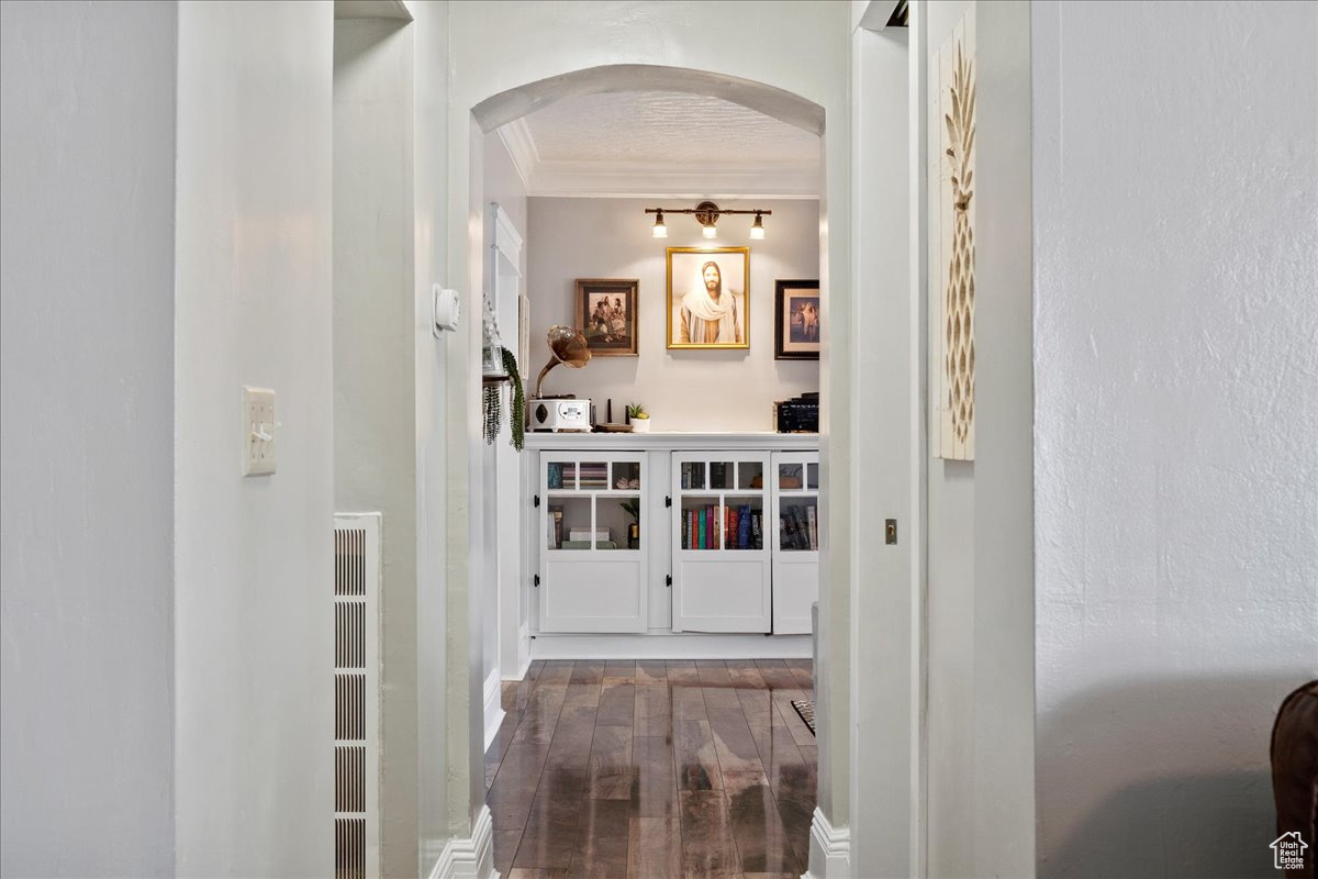 Hall featuring crown molding and hardwood / wood-style floors