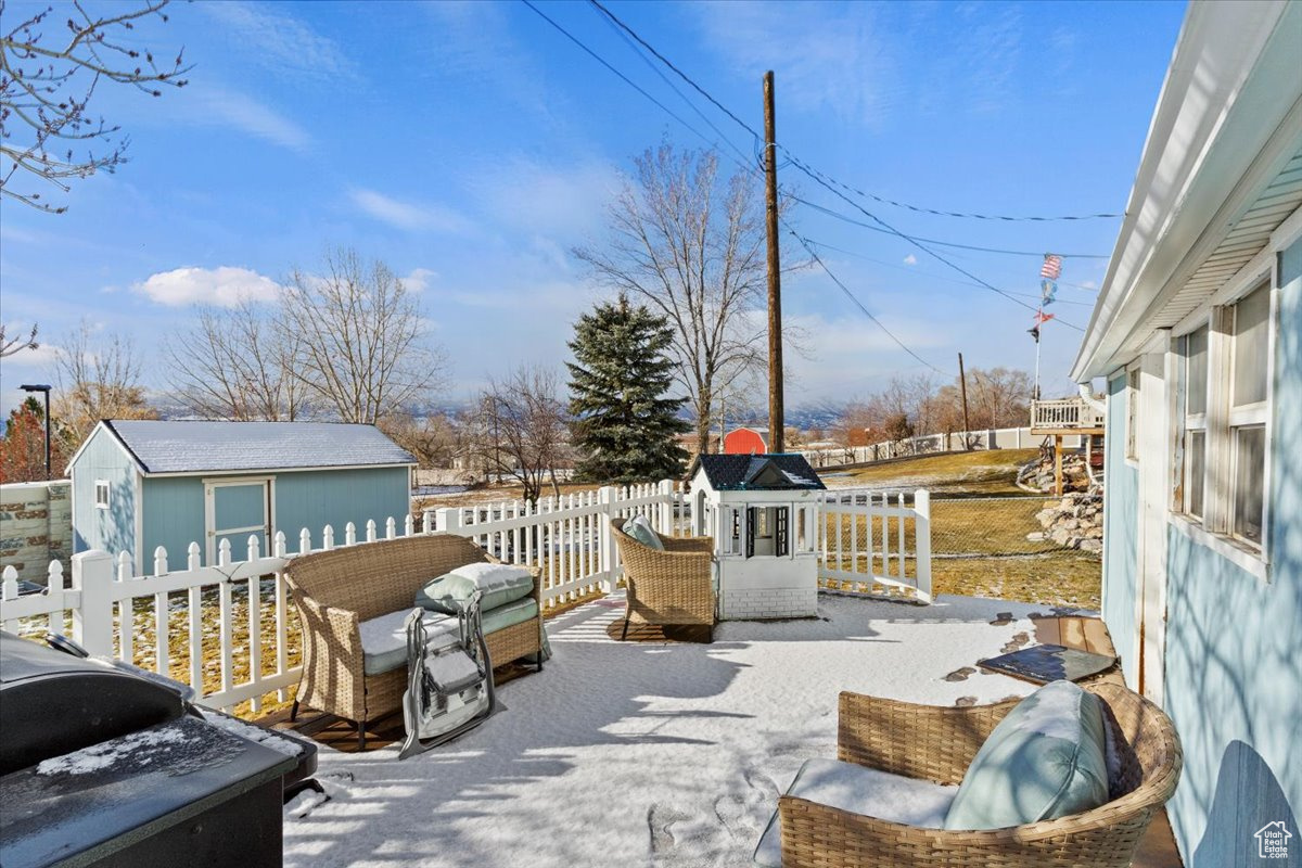 Wooden deck featuring an outdoor structure