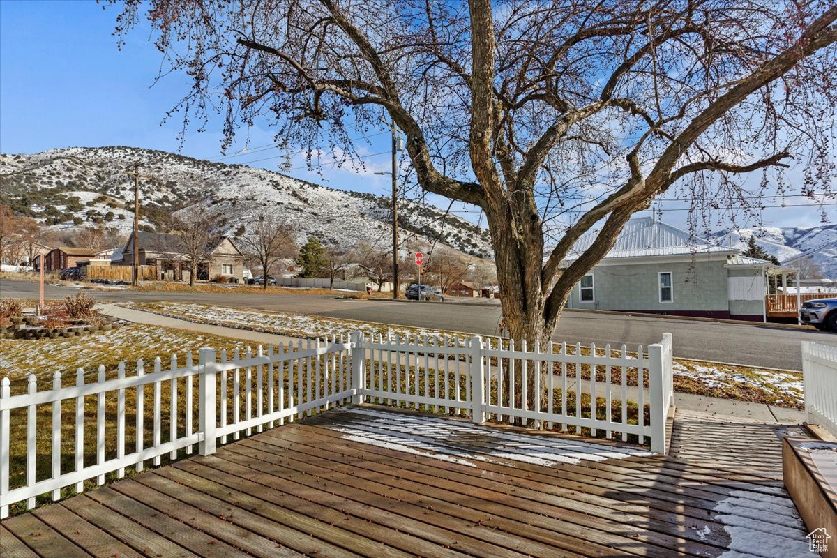 Snow covered deck with a mountain view