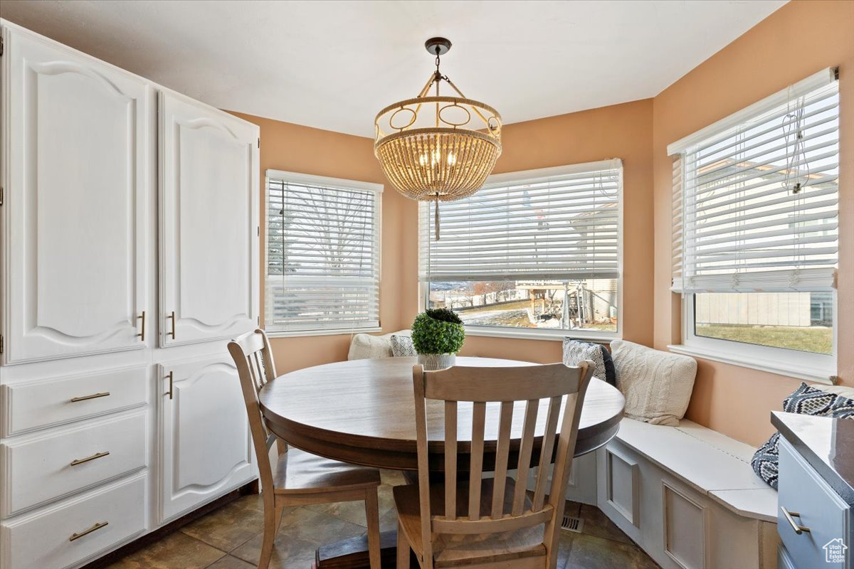 Dining area with dark tile patterned floors and breakfast area