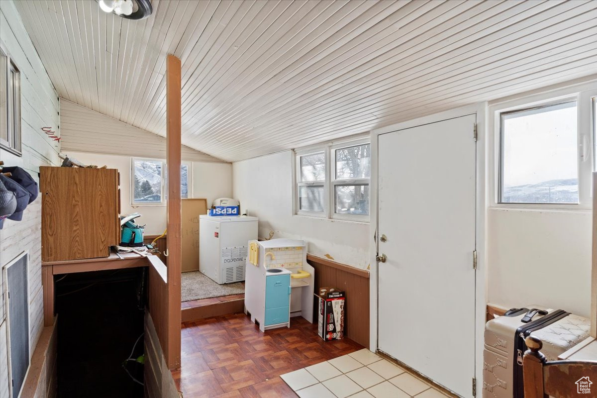 Clothes washing area featuring parquet floors and wood ceiling