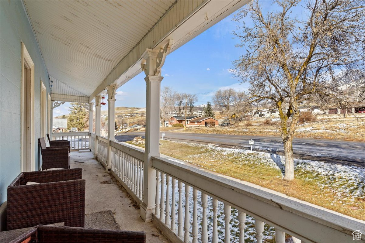 View of snow covered back of property