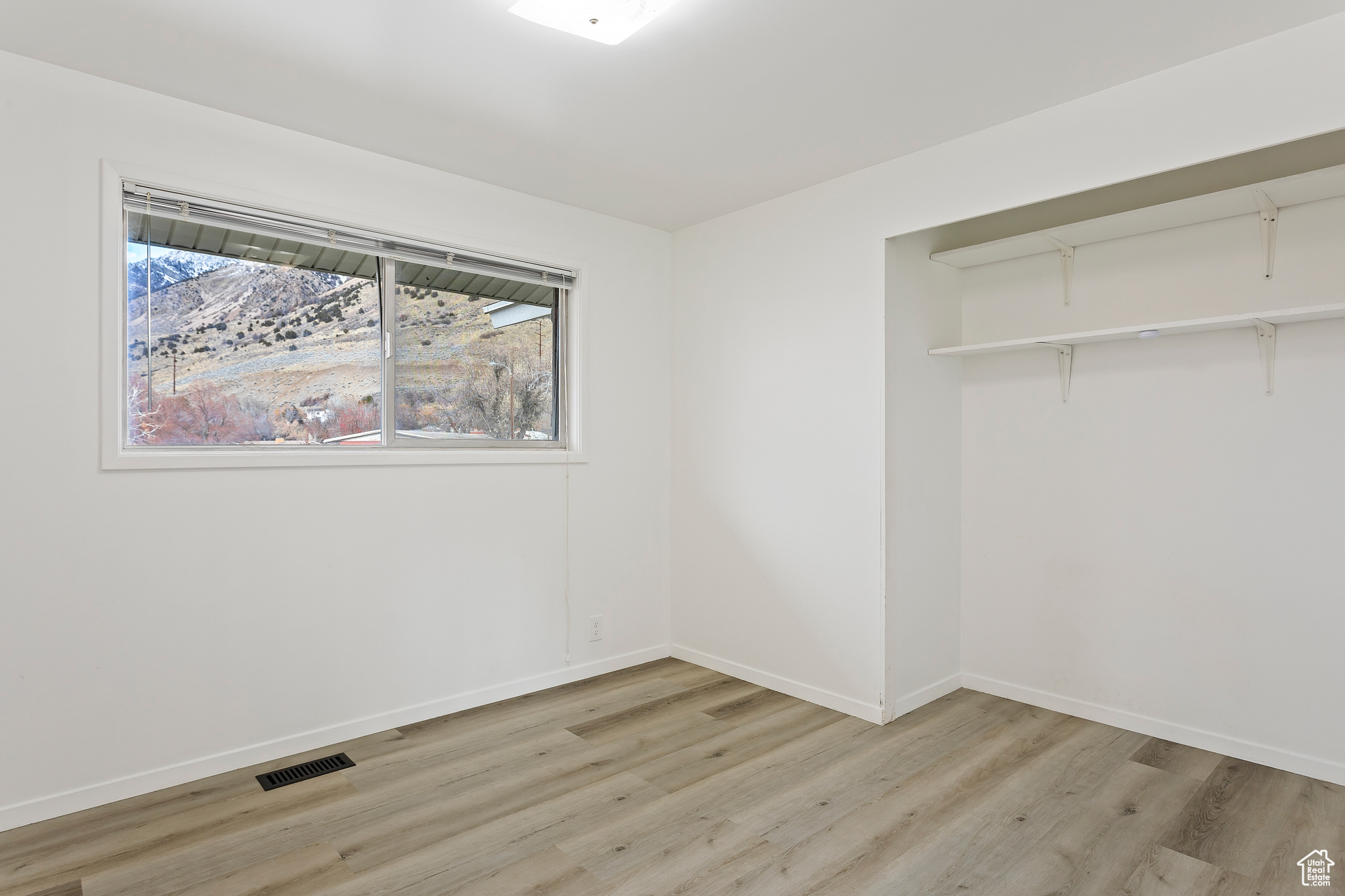 Unfurnished bedroom with a closet and light wood-type flooring