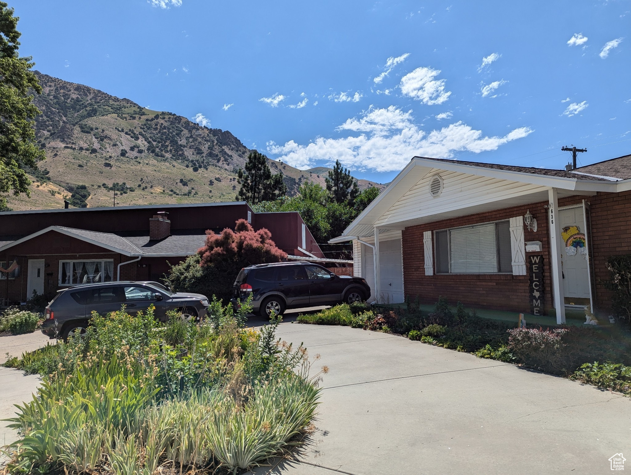 View of front of house with a mountain view and a garage