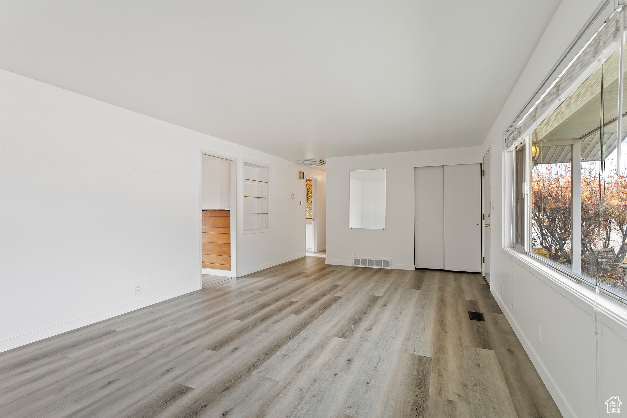 Unfurnished living room featuring light wood-type flooring