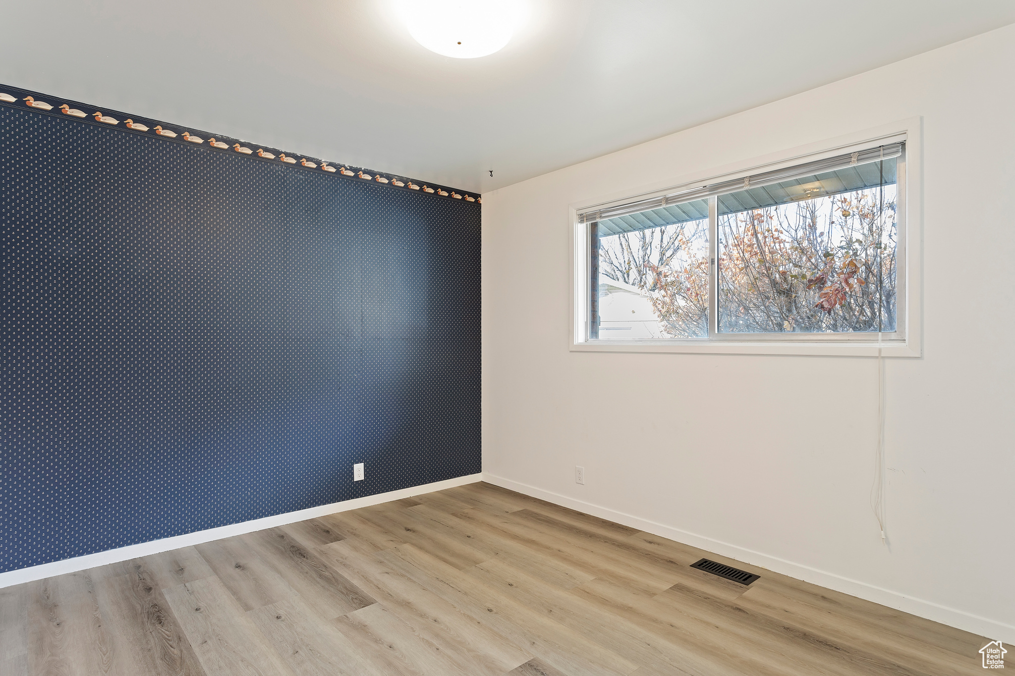 Spare room with light hardwood / wood-style floors