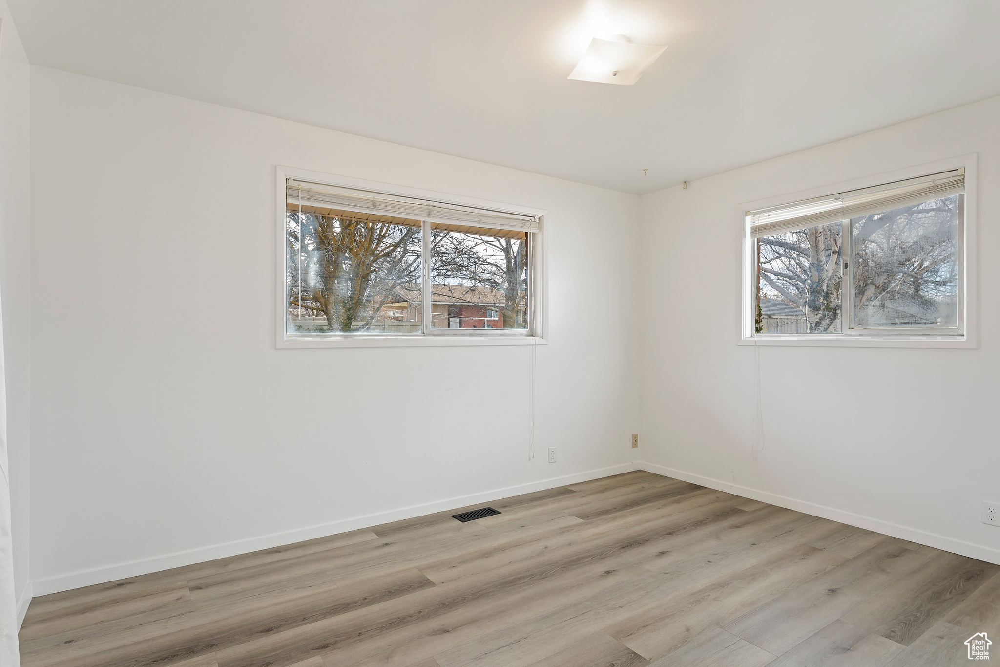 Empty room with light wood-type flooring