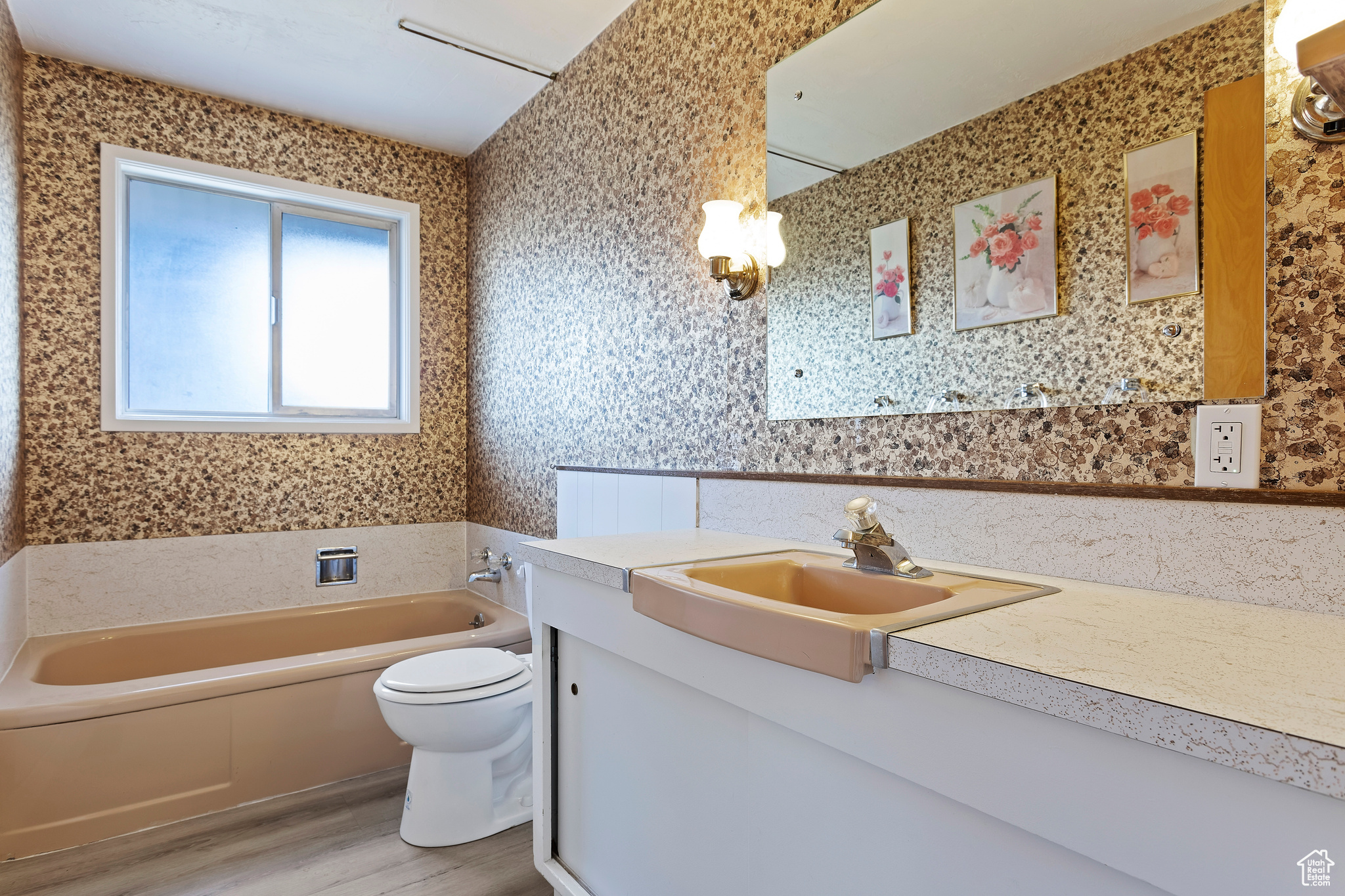 Bathroom featuring a bath, vanity, toilet, and wood-type flooring