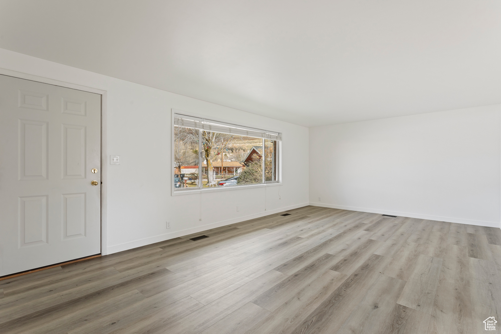 Unfurnished room with light hardwood / wood-style floors