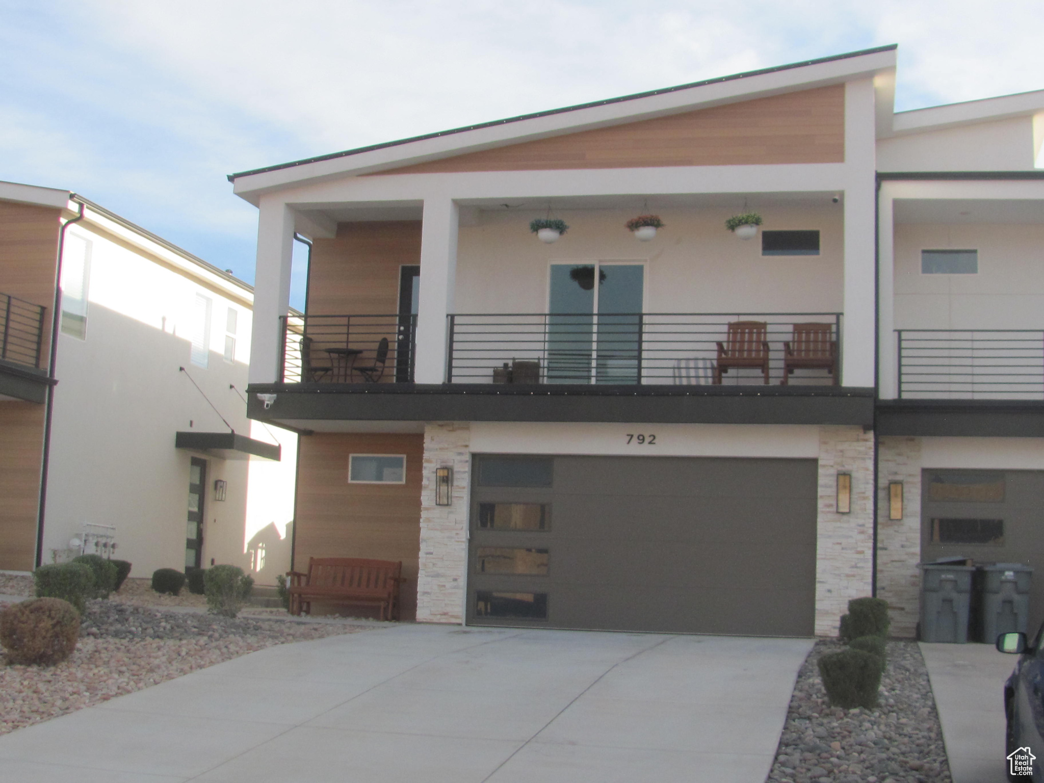 View of front facade with a balcony and a garage