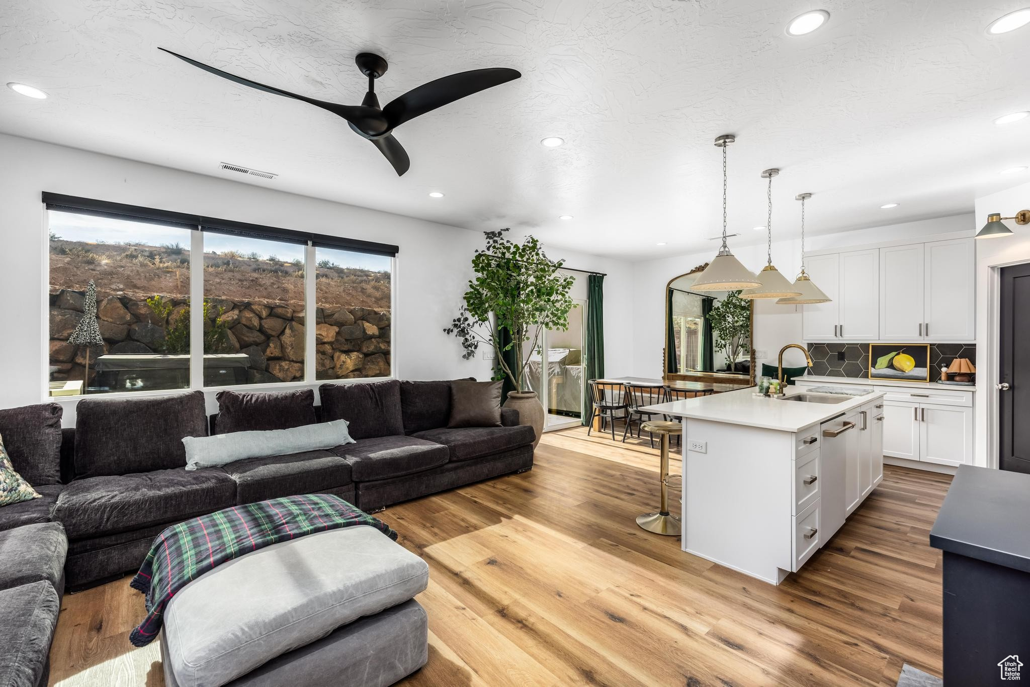 Living room/Great room area featuring ceiling fan, sink, and light hardwood / wood-style flooring