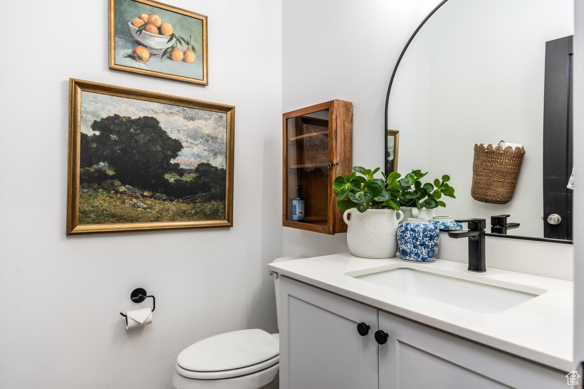 Half Bath on main floor featuring vanity and toilet