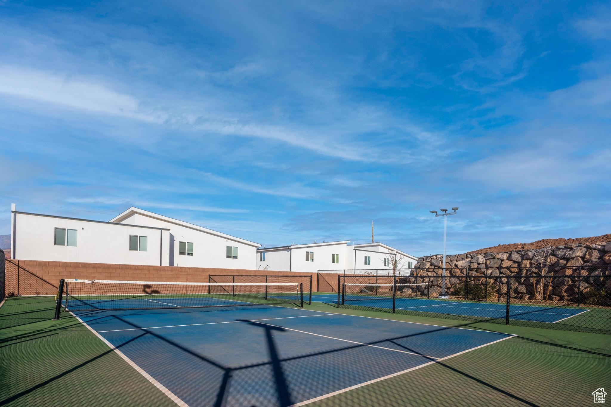 View of tennis/pickleball court with basketball court