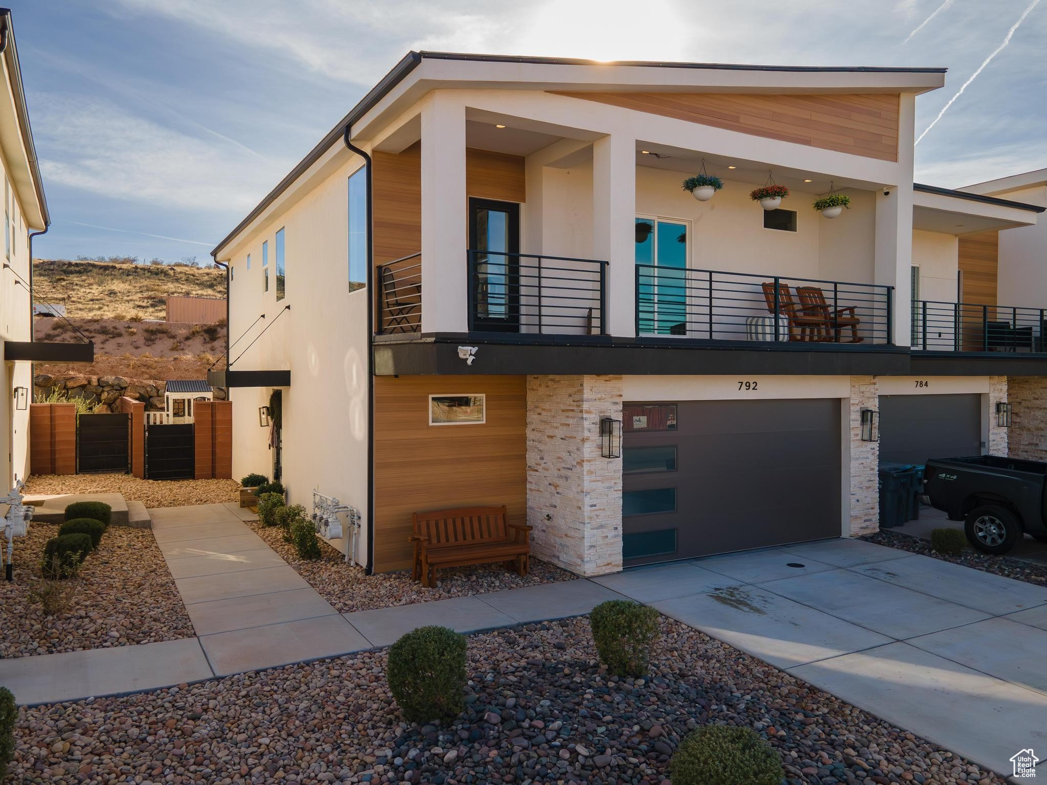 Front view featuring a balcony and a garage