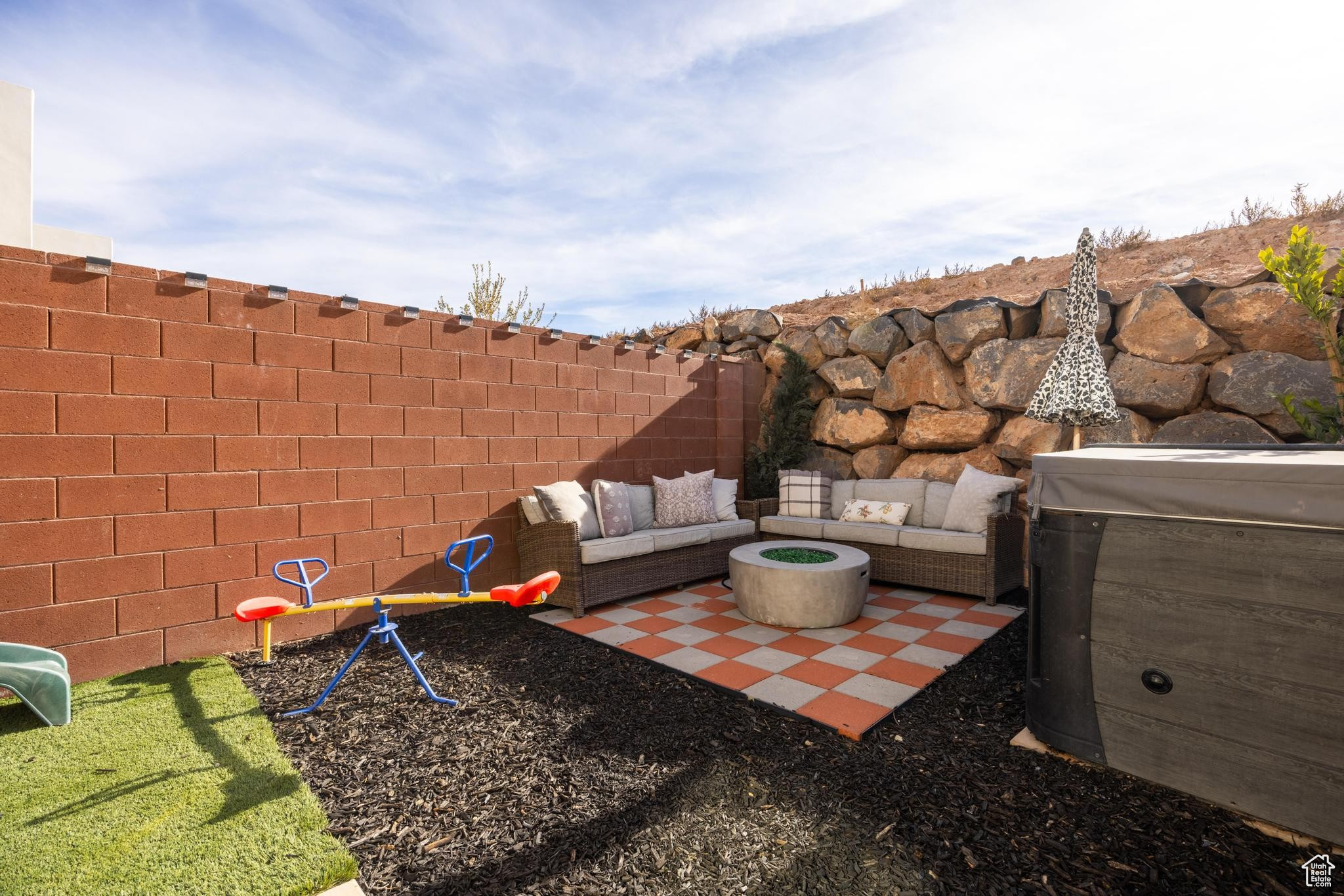 Exterior space with a firepit, hot tub and an outdoor hangout area