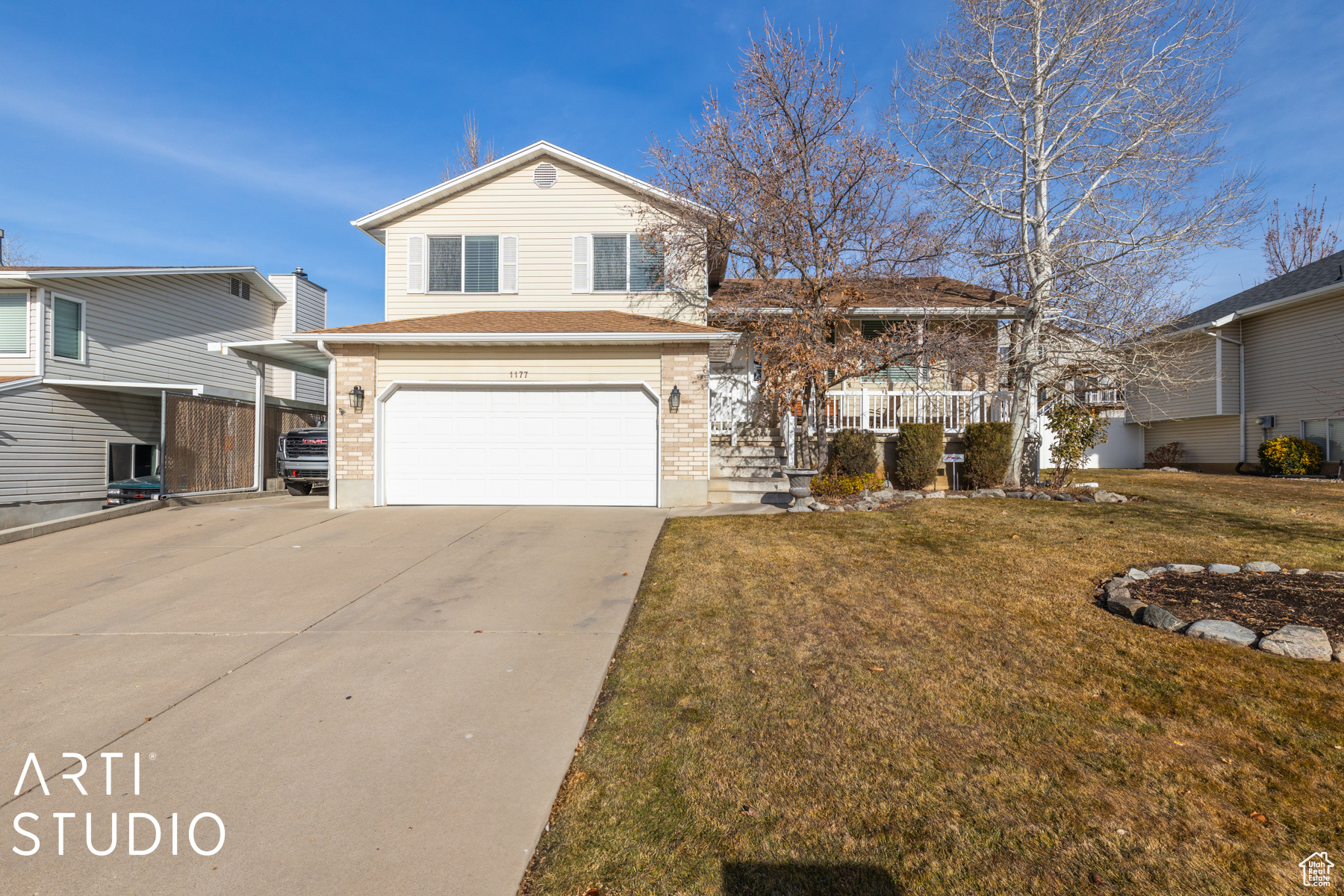 Split level home with a front yard and a garage