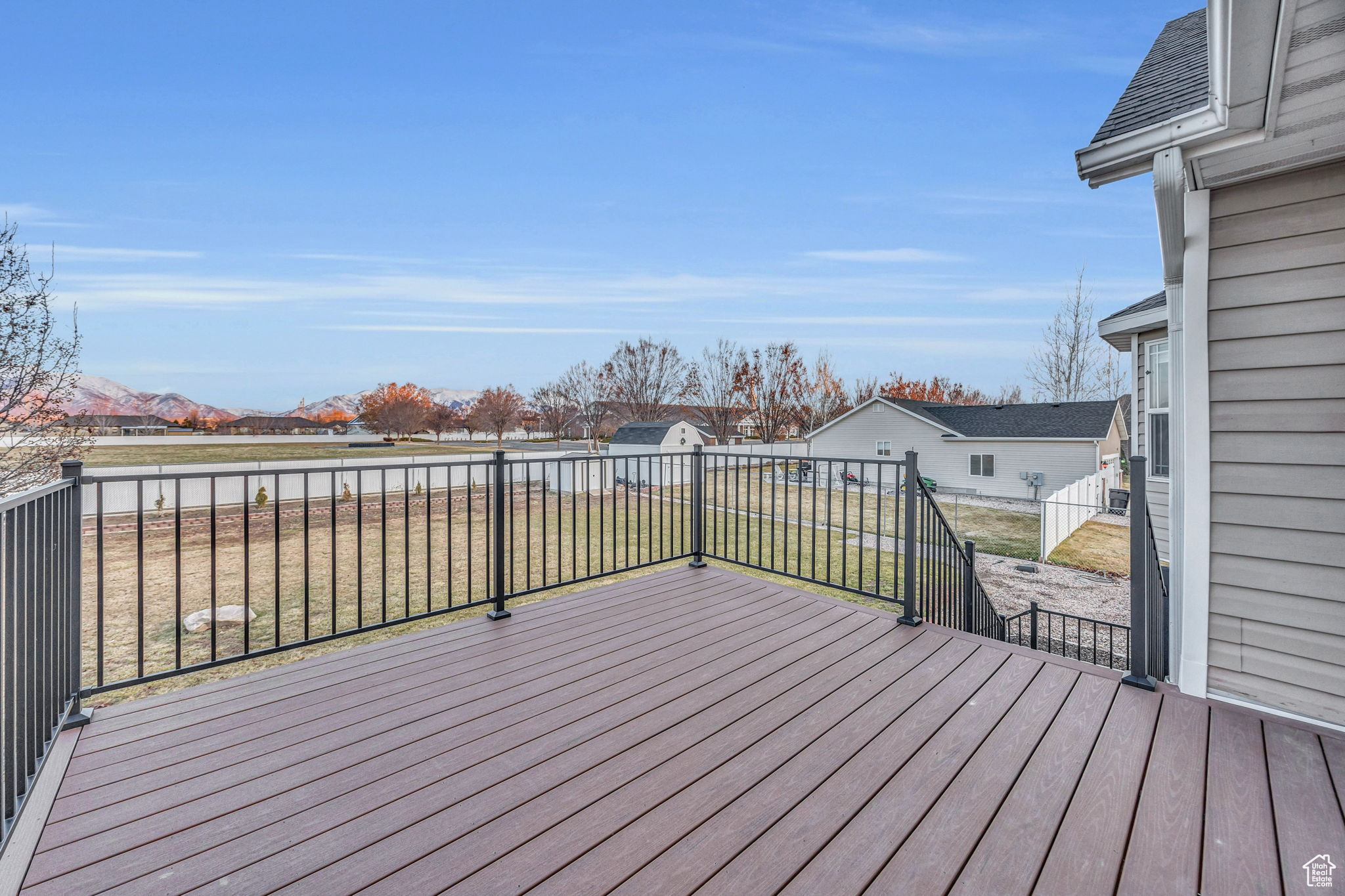 Wooden deck with a mountain view and a lawn