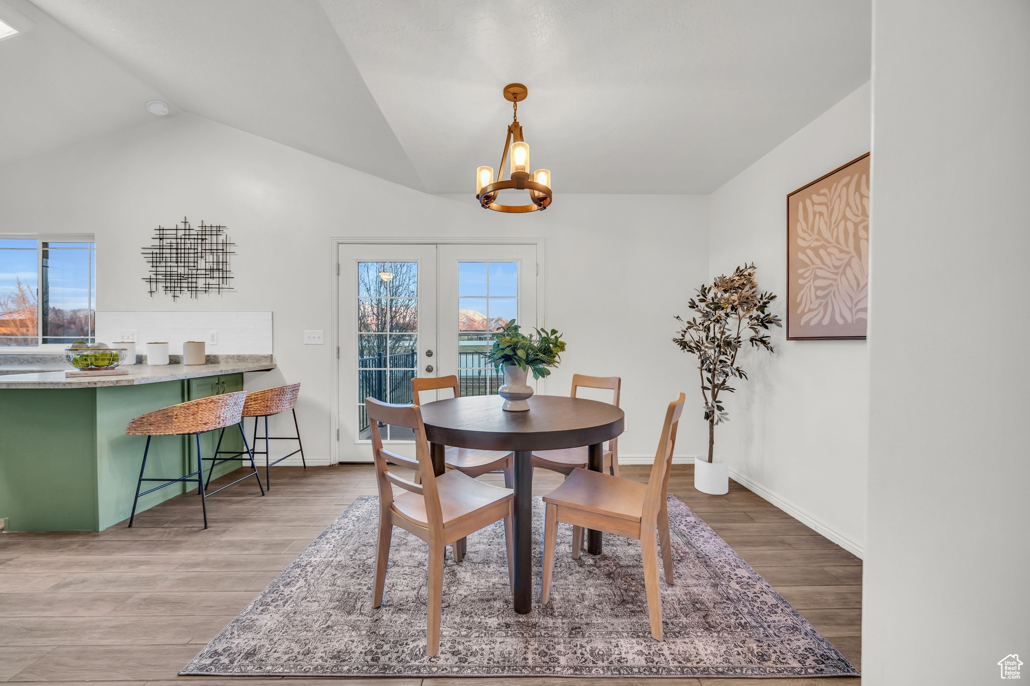 Dining room featuring a wealth of natural light, french doors, tile wood-style flooring