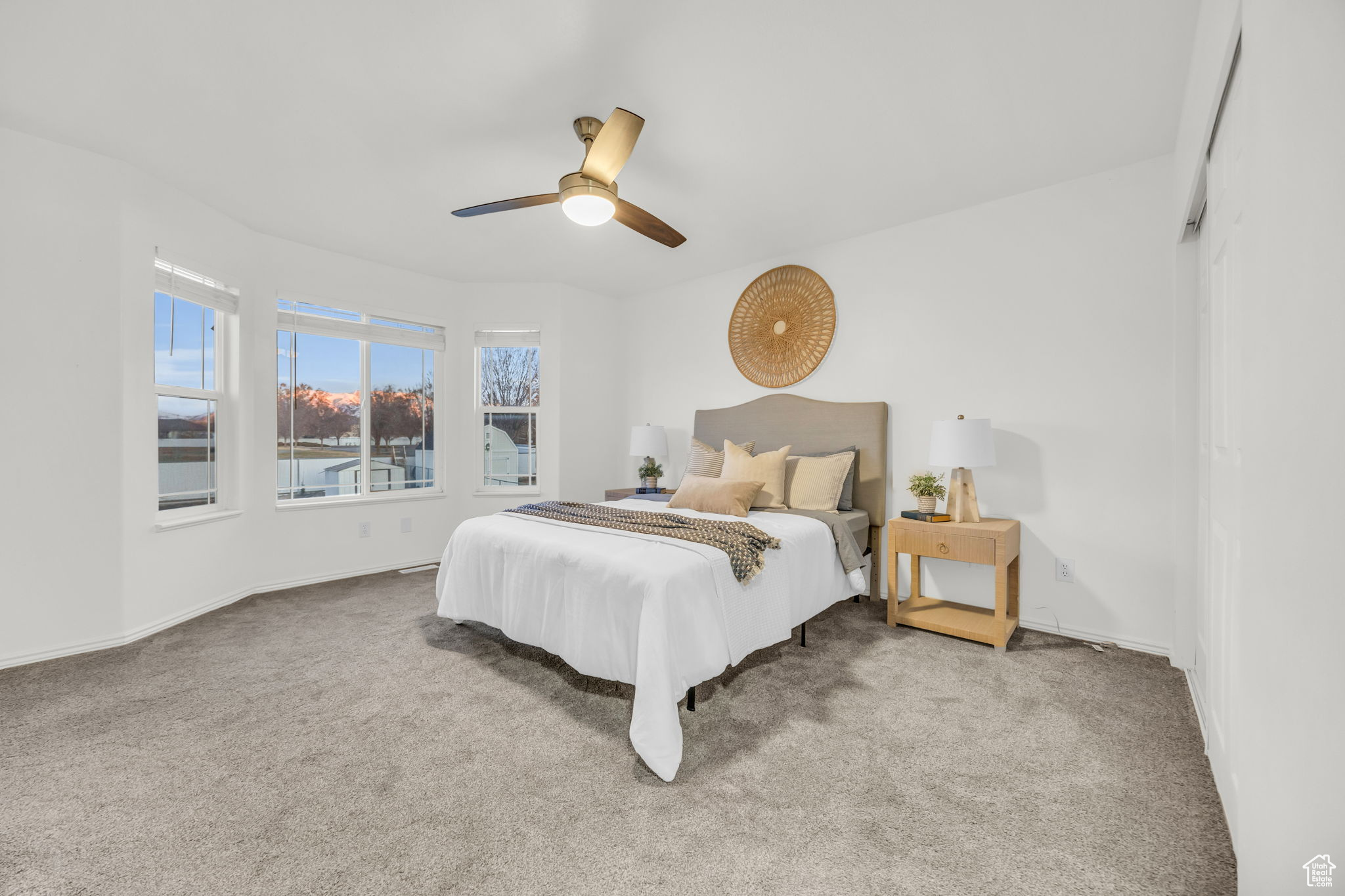 Carpeted bedroom featuring ceiling fan