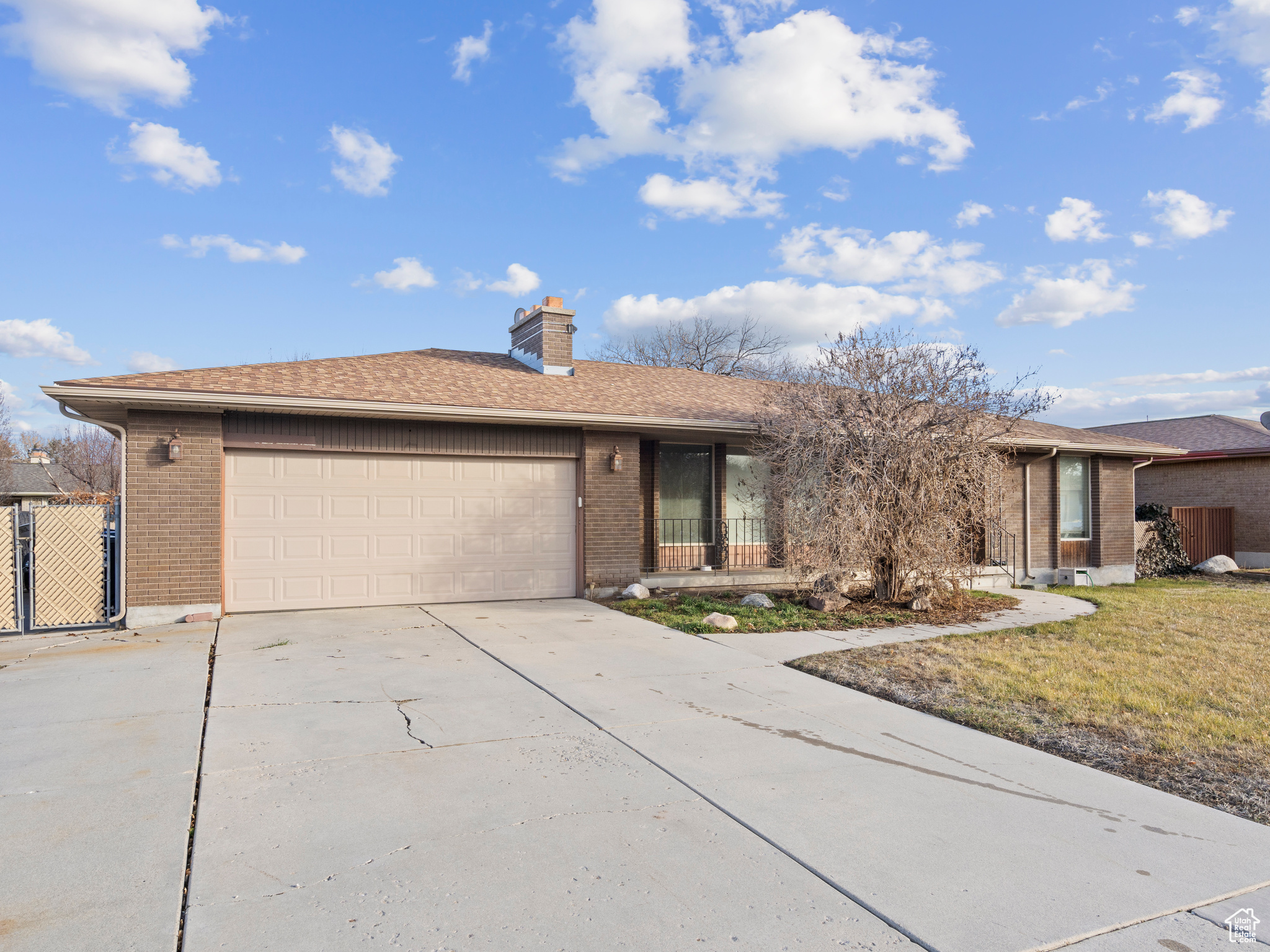 Single story home featuring a garage and a front yard