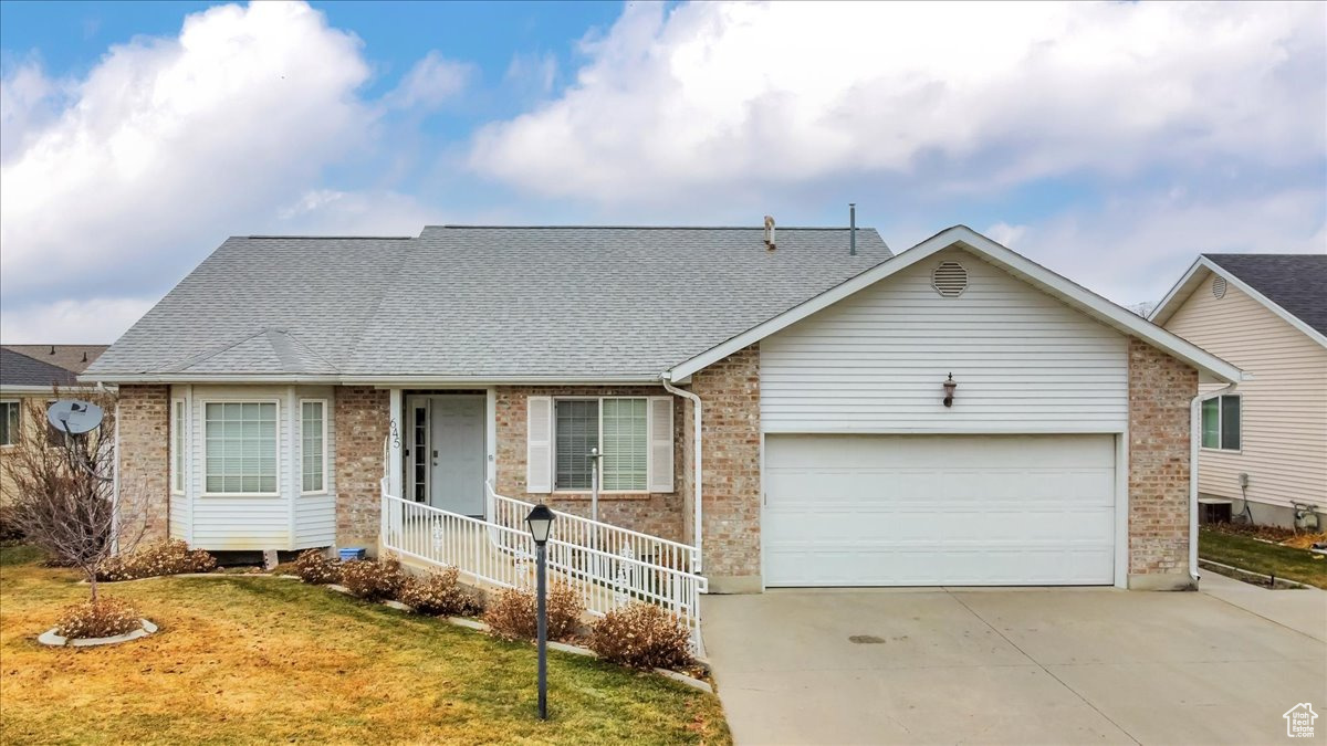 Single story home with a front lawn and a garage