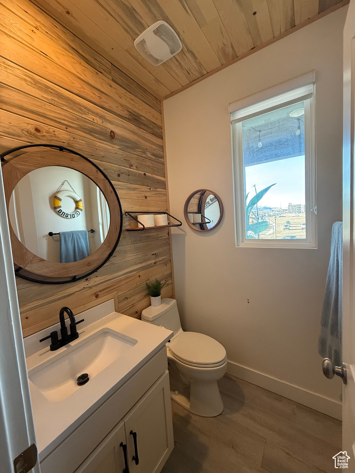 Bathroom featuring wood ceiling, vanity, wood-type flooring, toilet, and wood walls