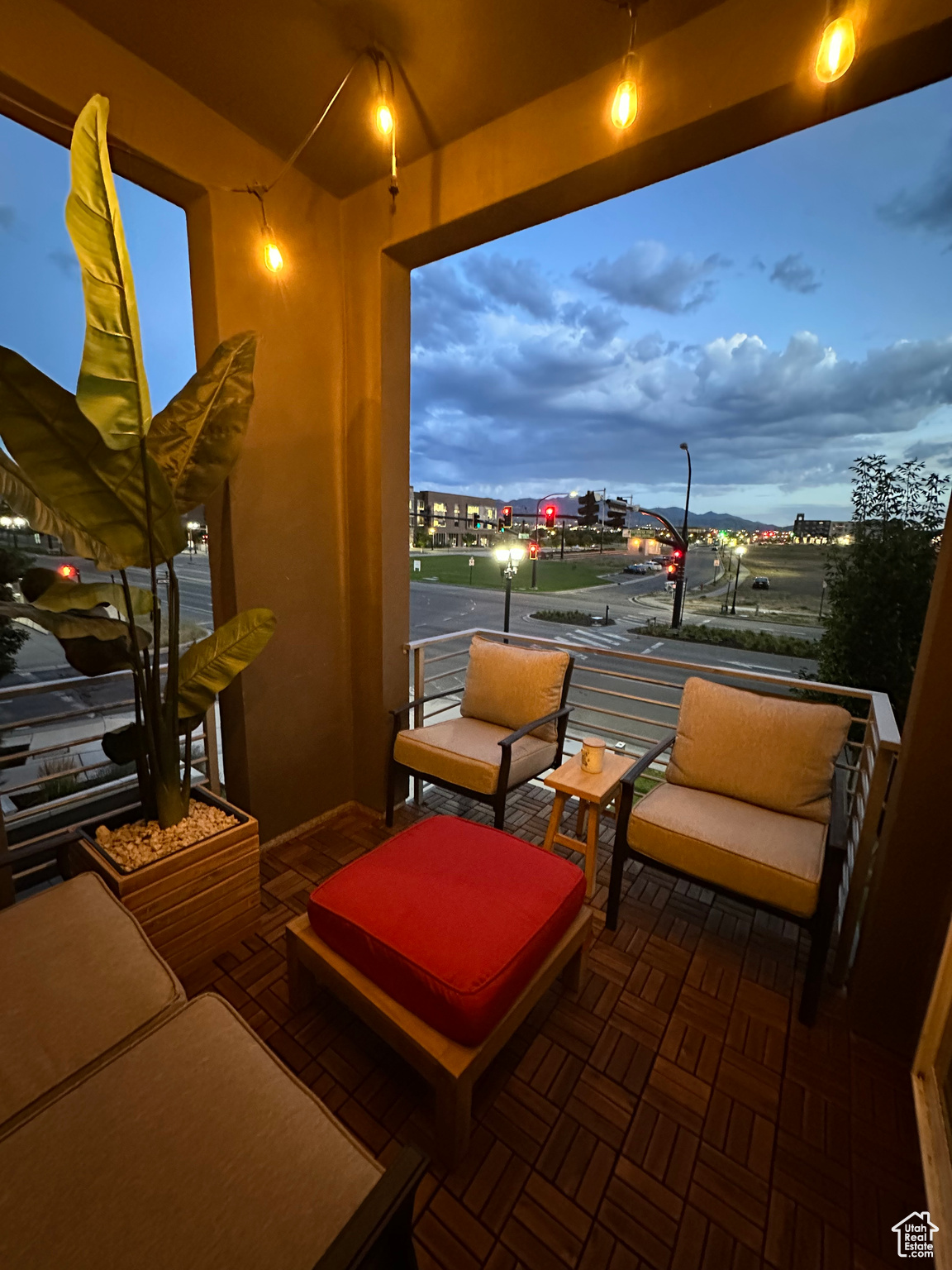 Patio terrace at dusk featuring a balcony