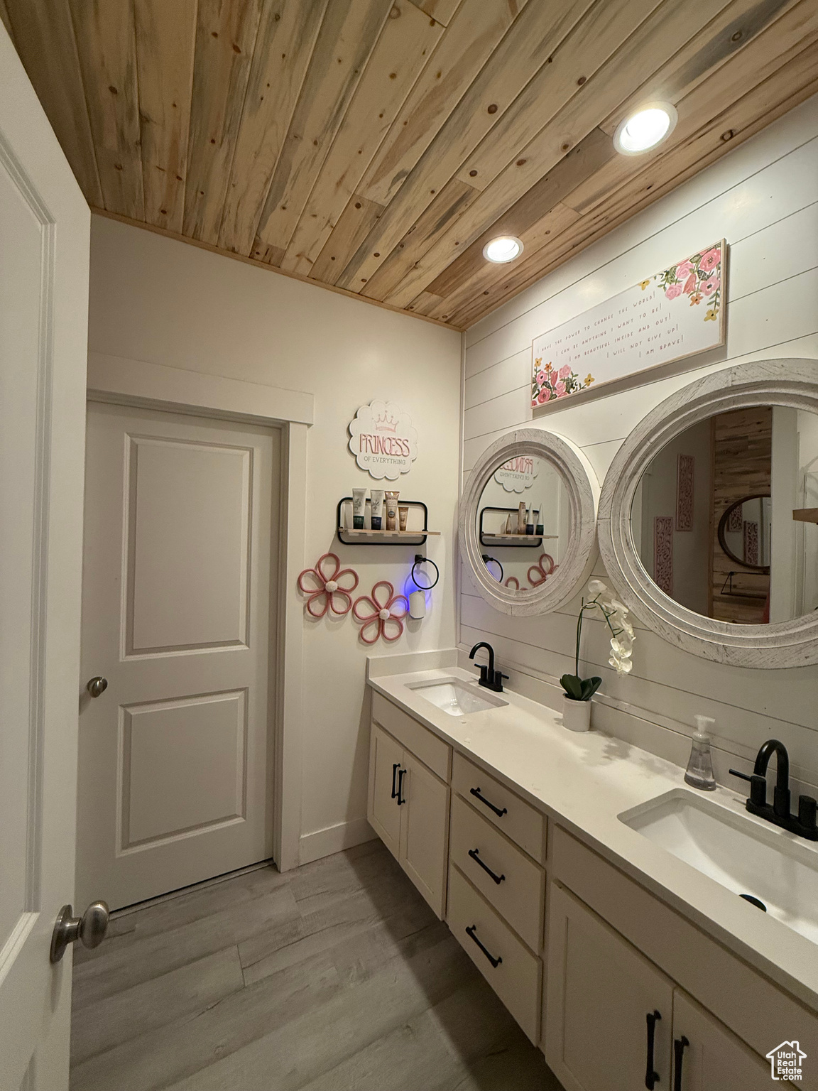 Bathroom featuring hardwood / wood-style floors, vanity, wooden ceiling, and wood walls