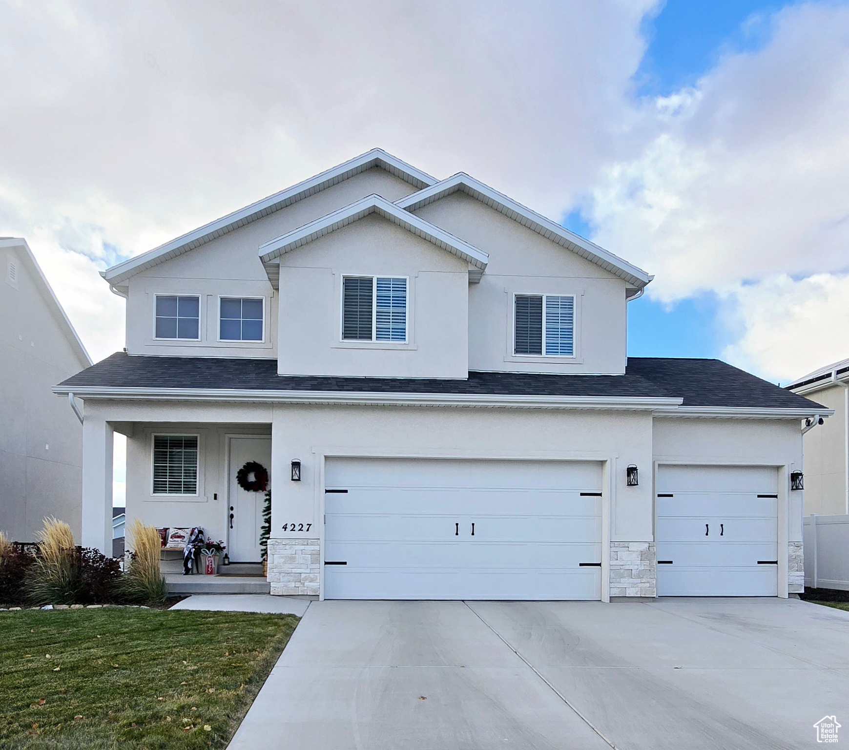 View of property featuring covered porch and a garage