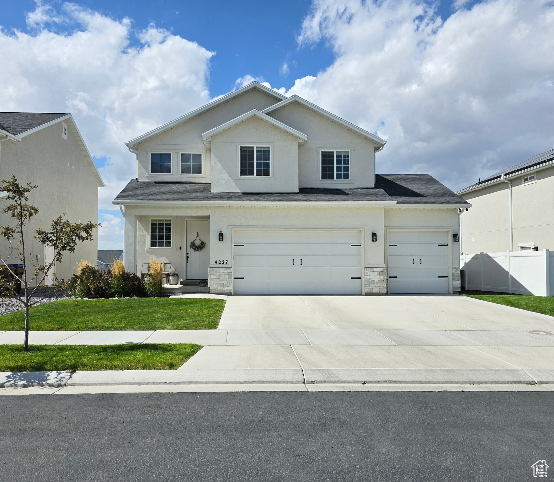 View of front of home with a garage and a front lawn