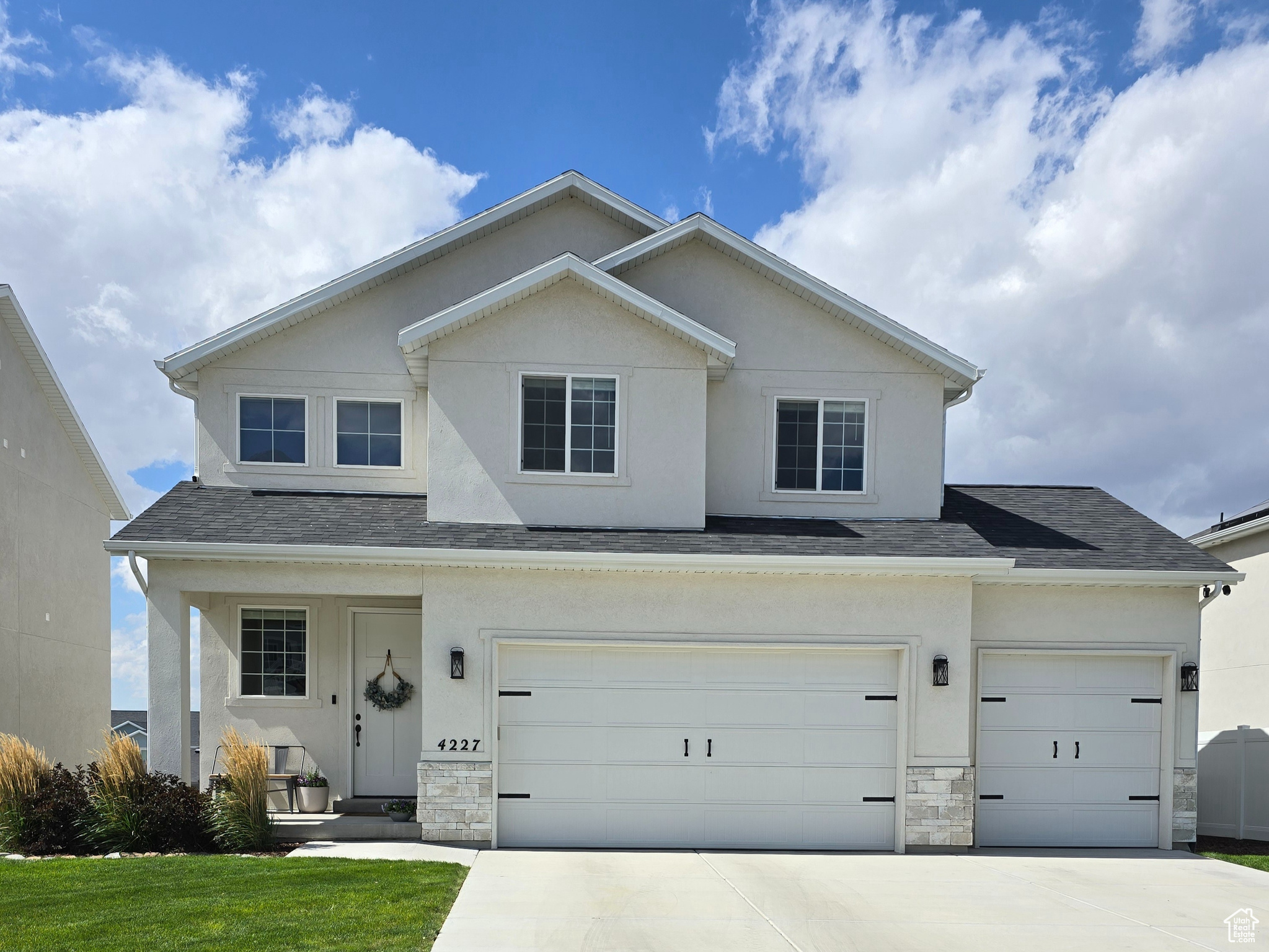 Front facade featuring a garage and a front lawn