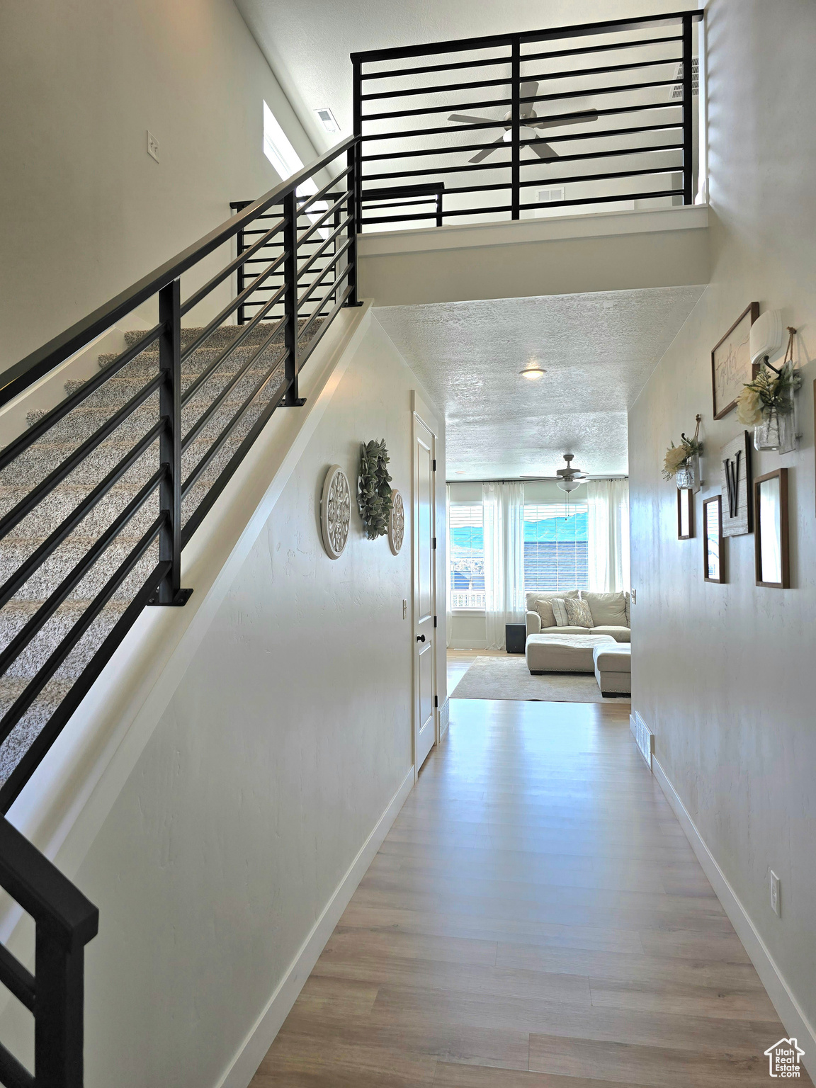 Corridor featuring a textured ceiling and hardwood / wood-style flooring