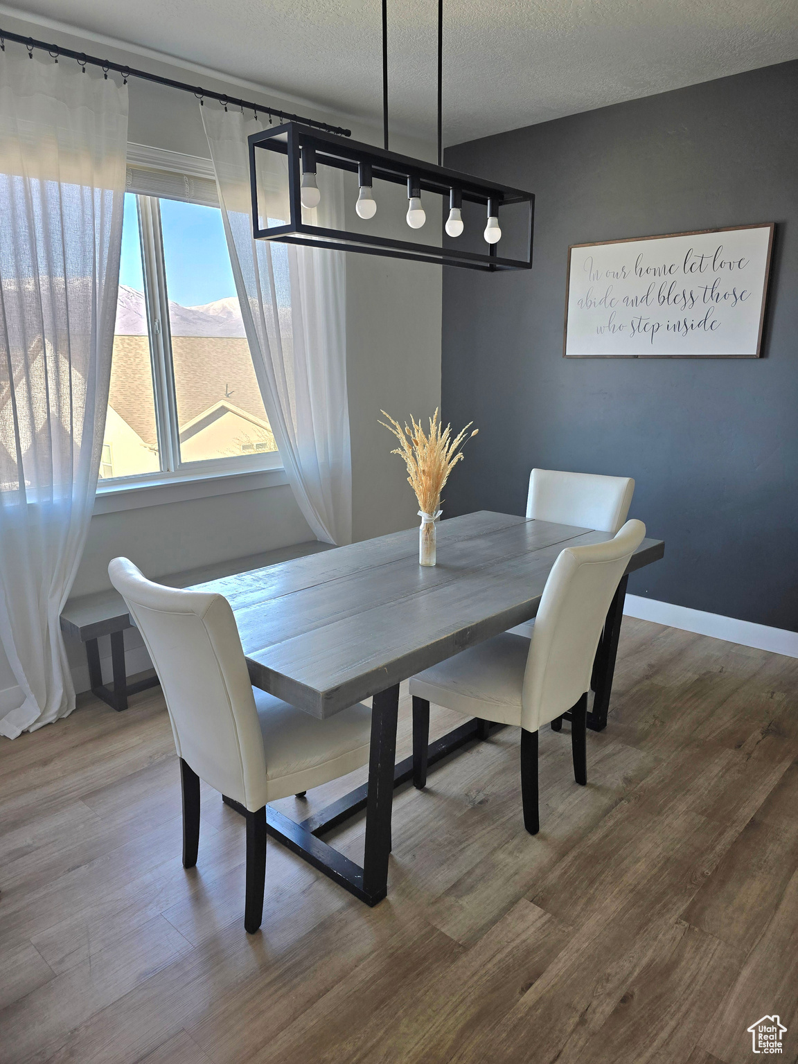 Dining space featuring wood-type flooring and a textured ceiling