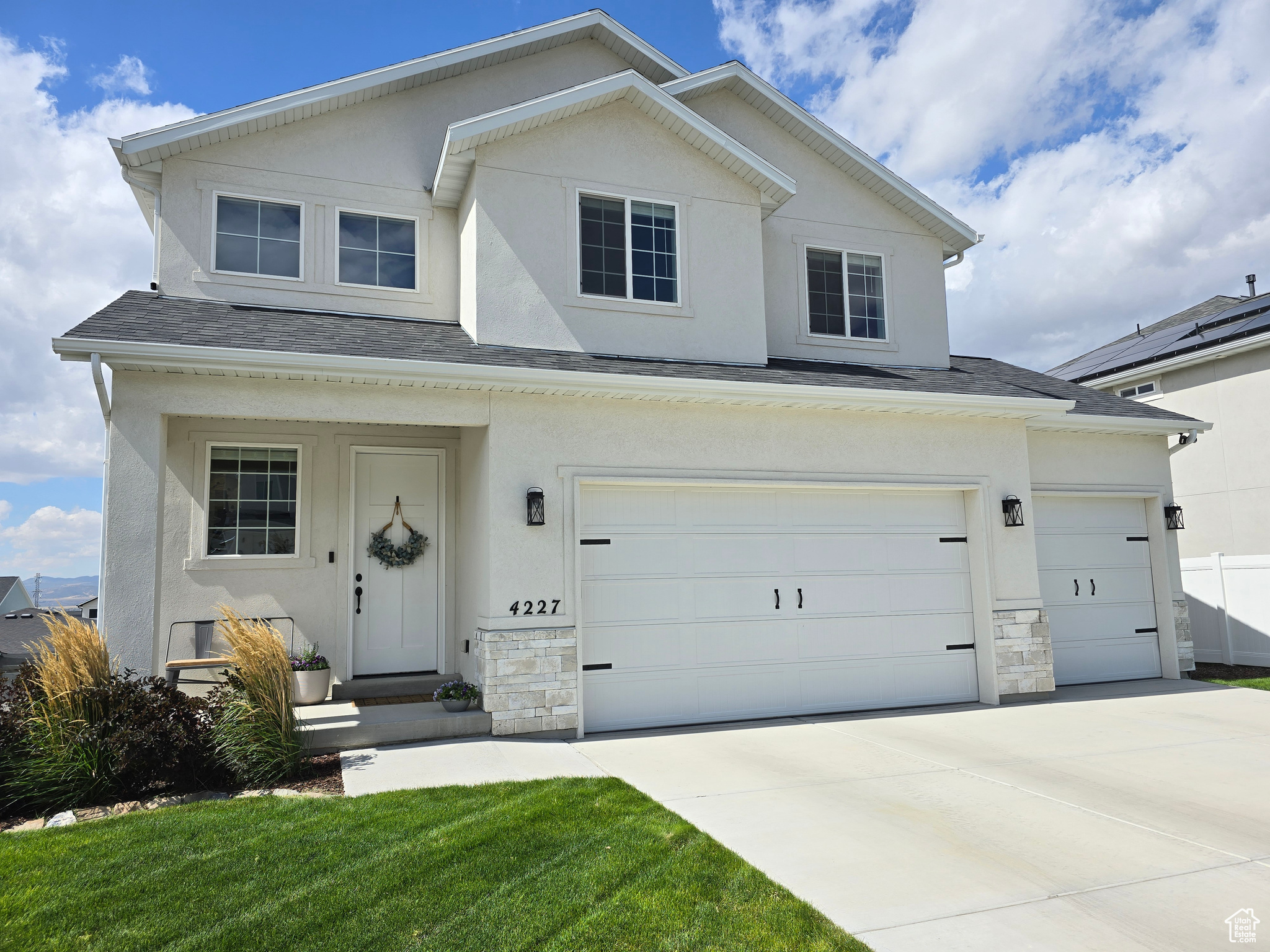 View of front of home featuring a garage and a front yard