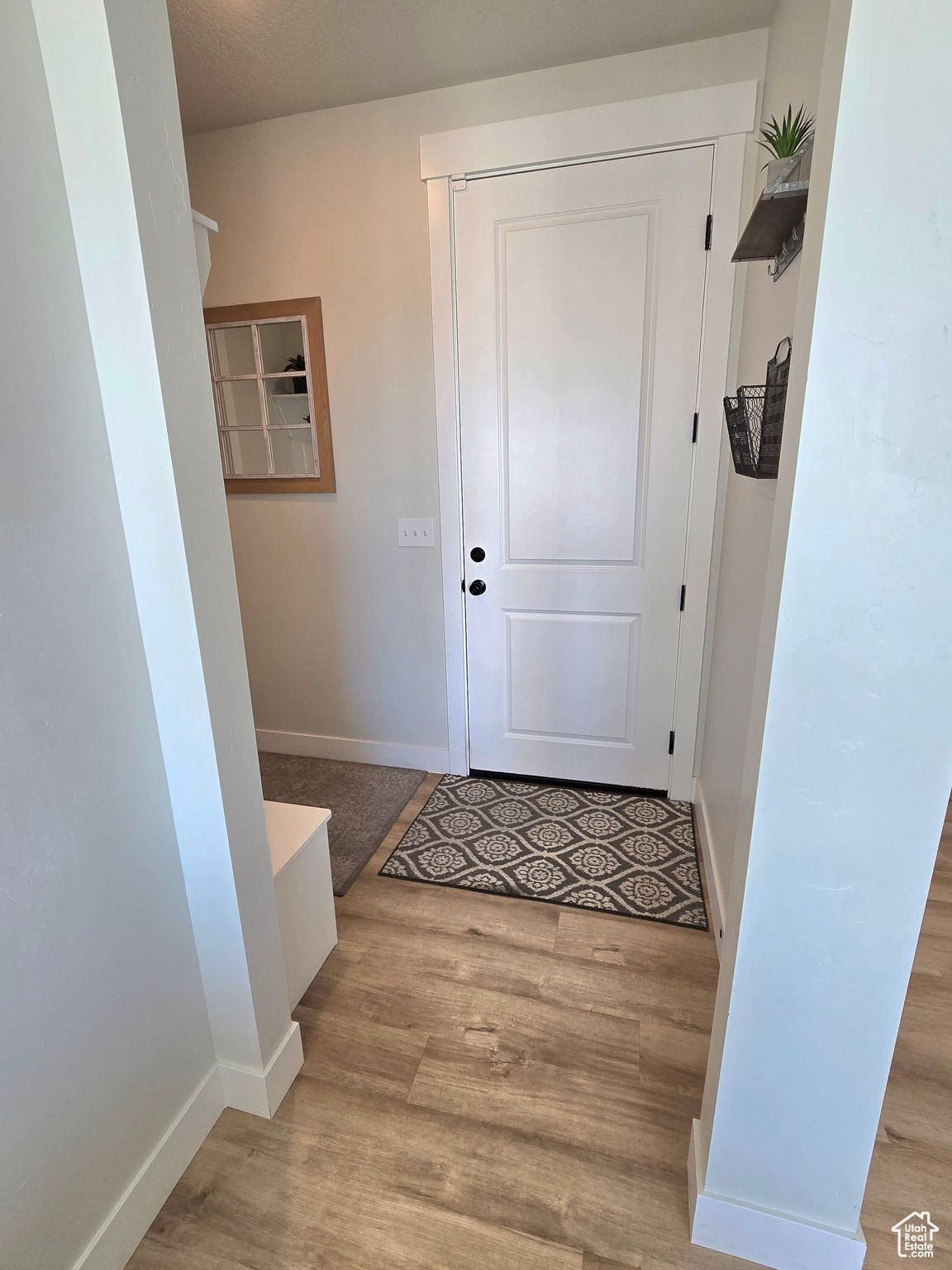 Doorway to outside with light wood-type flooring