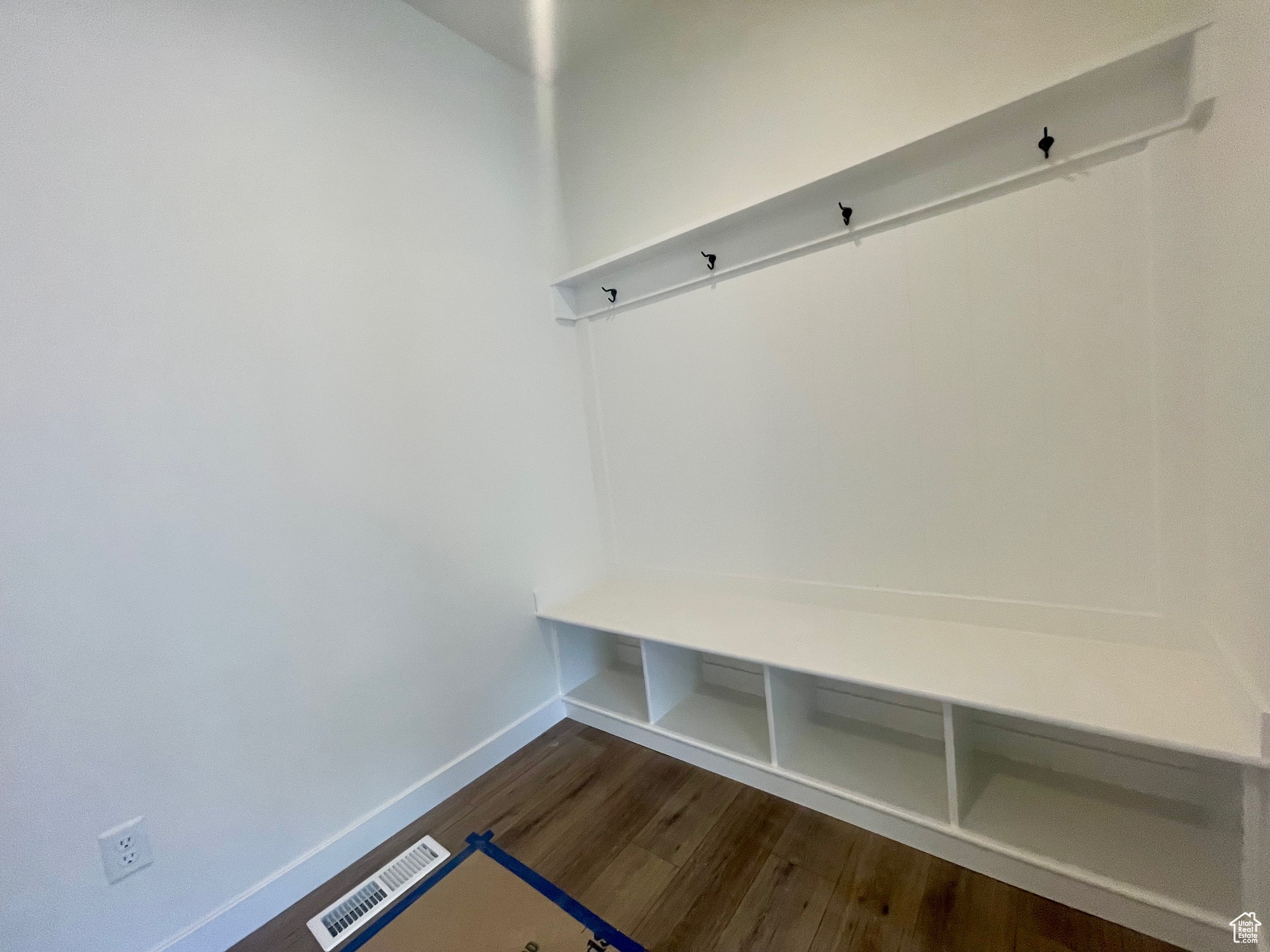 Mudroom with dark hardwood / wood-style flooring