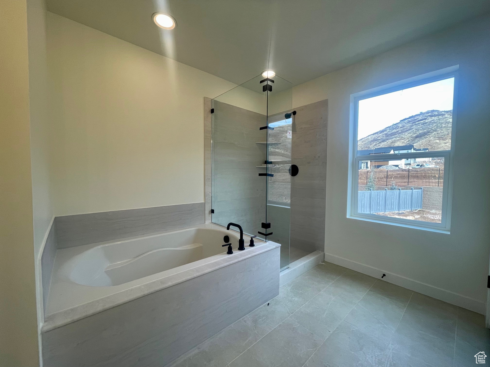 Primary Bathroom with a mountain view and shower with separate bathtub