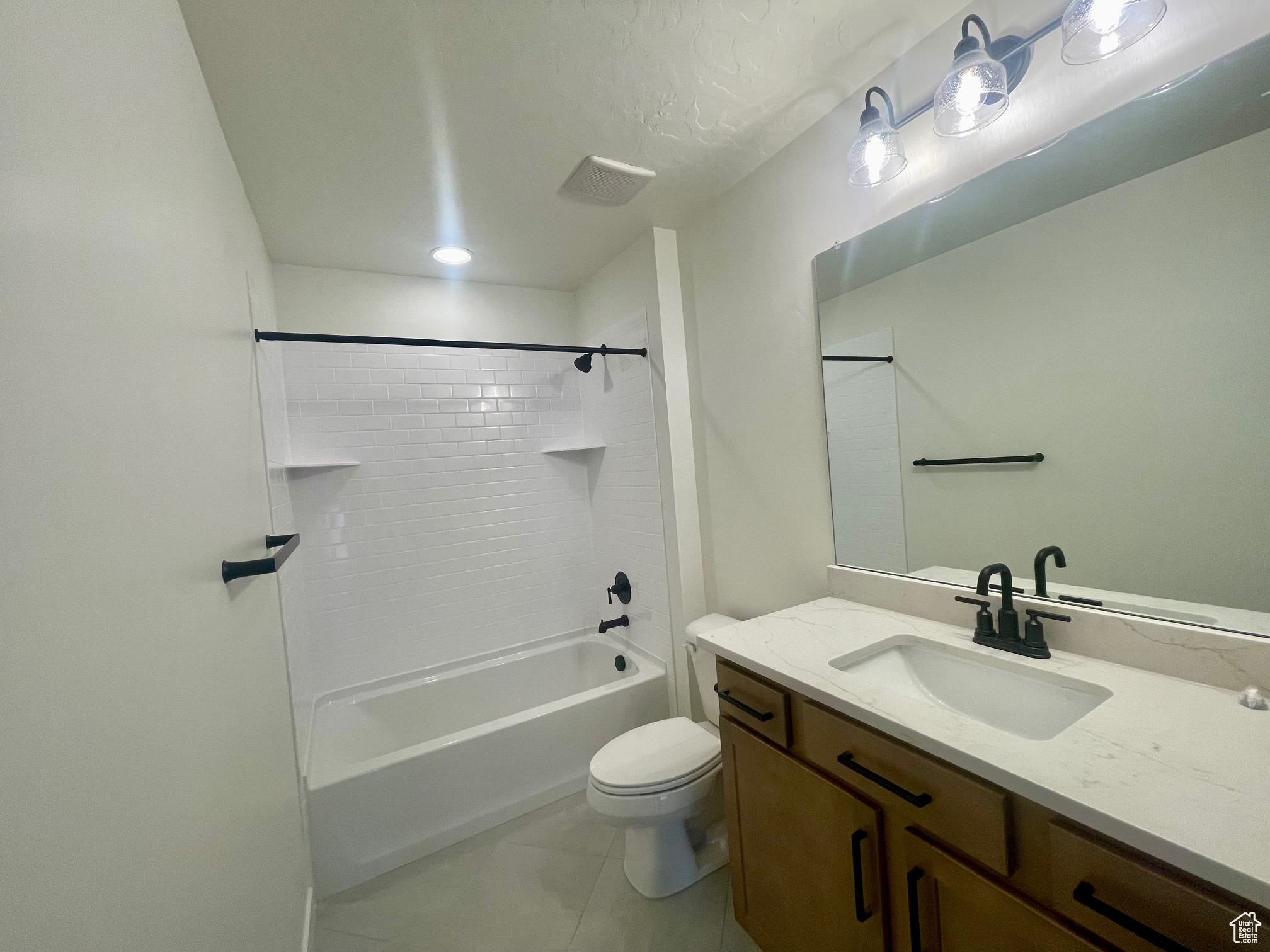 Full bathroom with tile patterned flooring, vanity, toilet, and shower / bathing tub combination