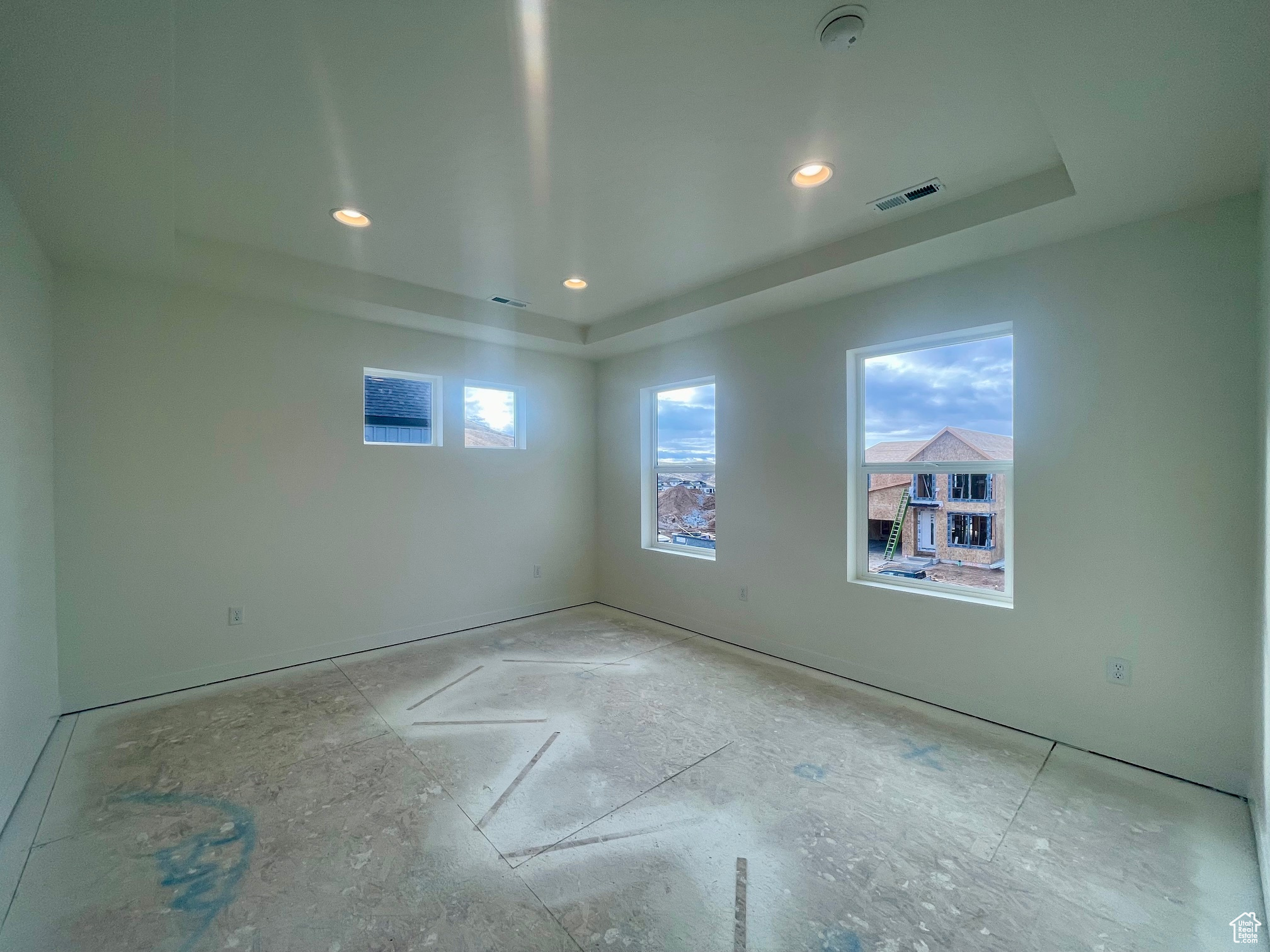 Primary bedroom room featuring a raised ceiling