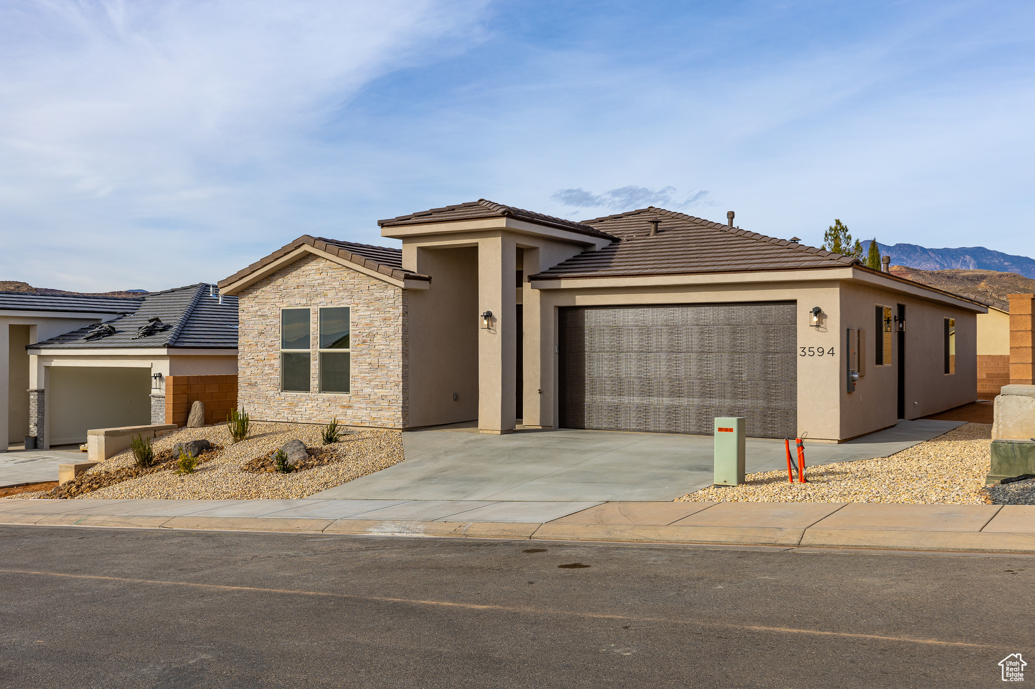 View of front facade featuring a mountain view and a garage