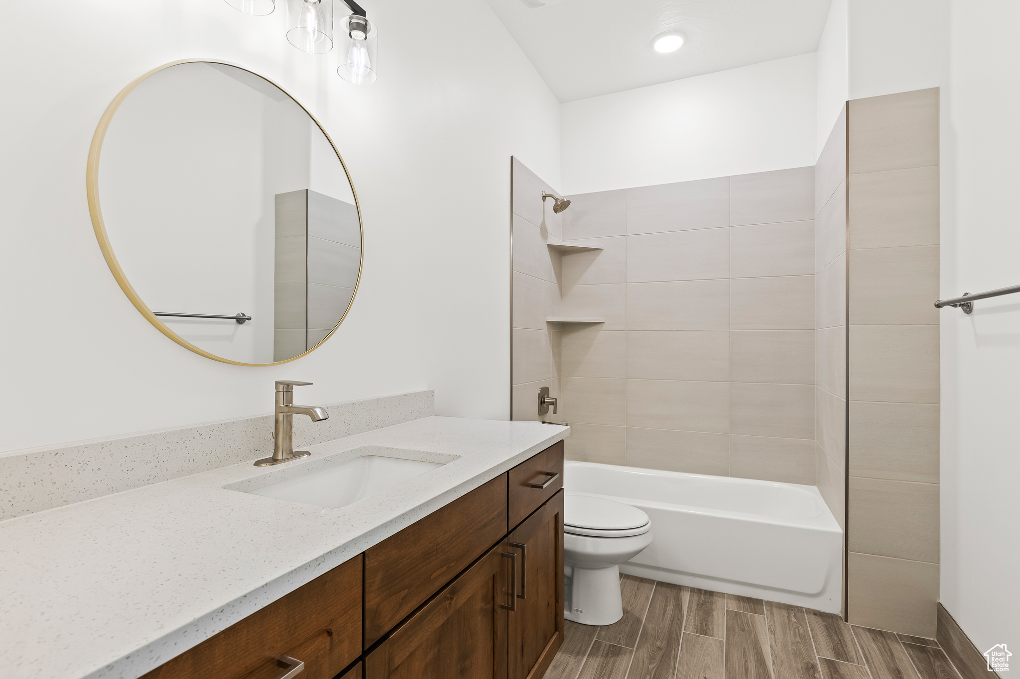 Full bathroom featuring toilet, vanity, and tiled shower / bath