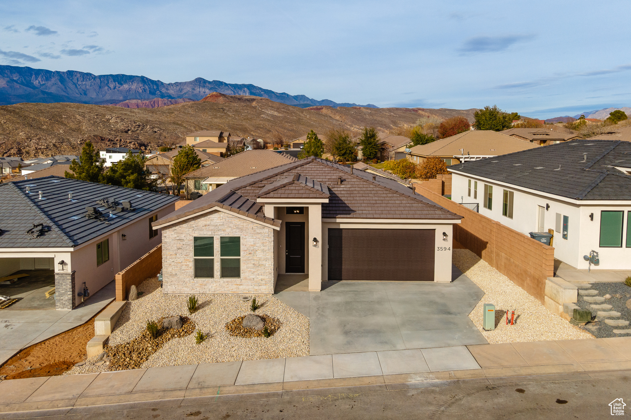 View of front of property with a mountain view and a garage