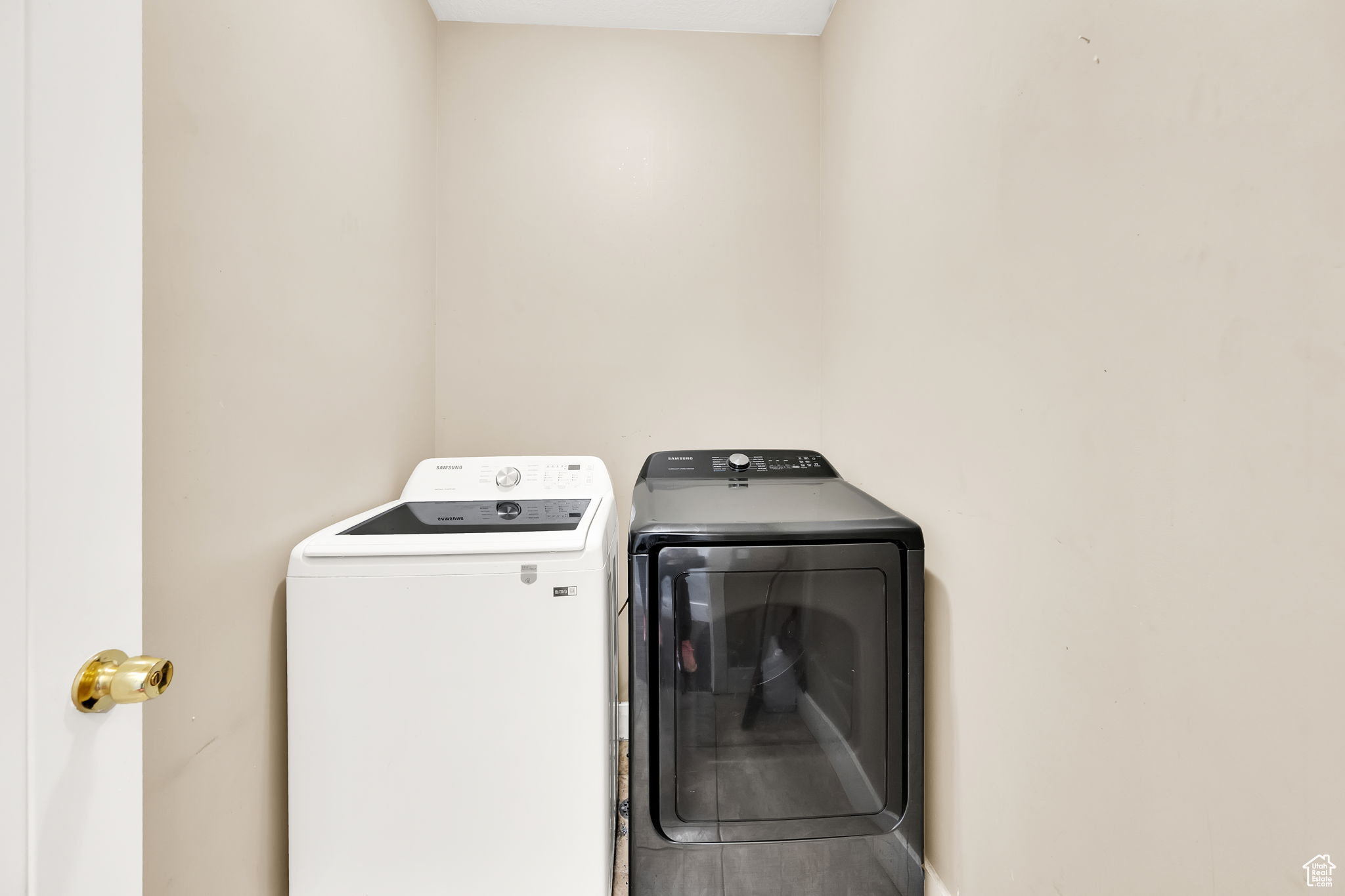 Clothes washing area featuring washing machine and clothes dryer