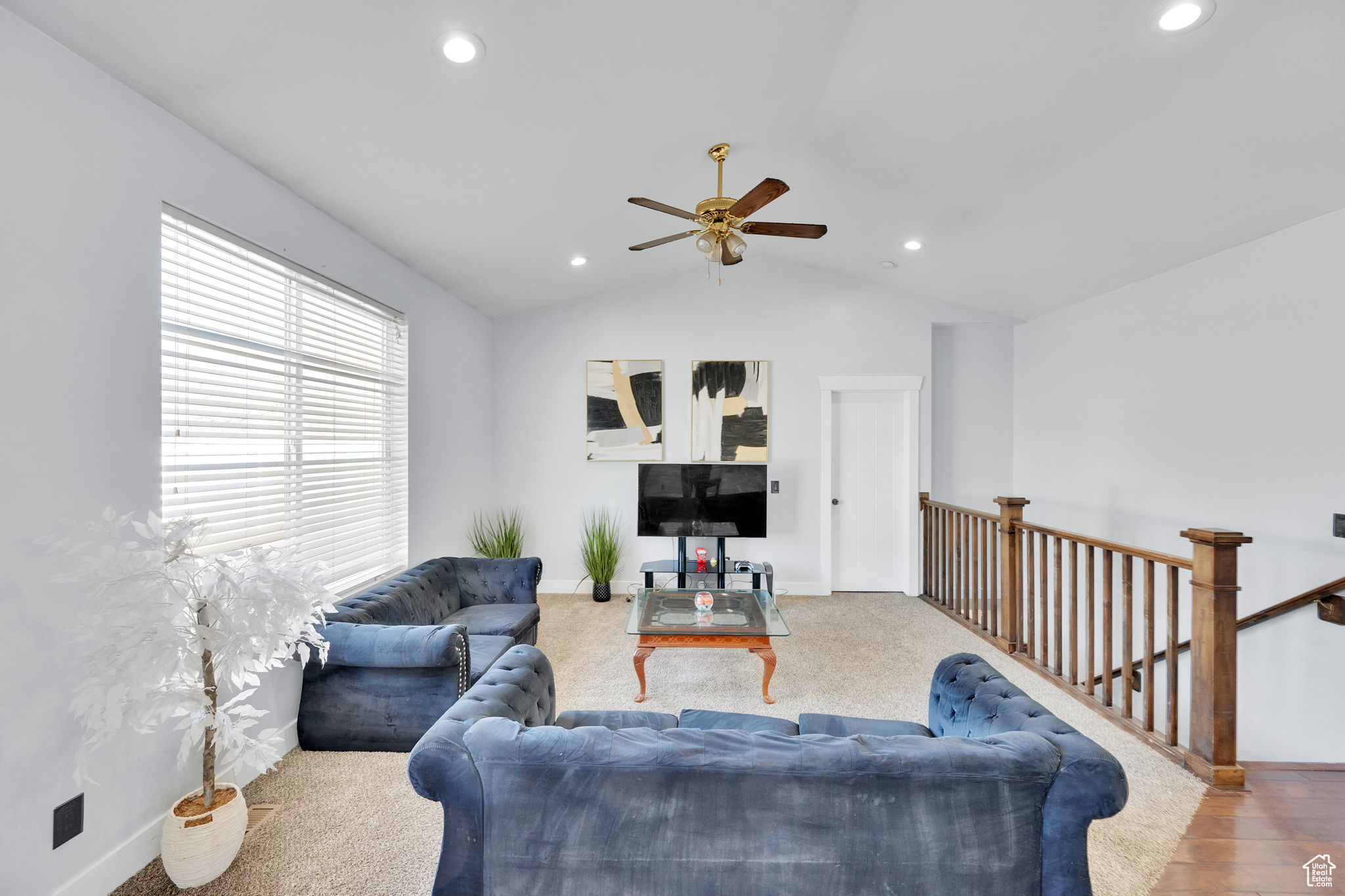 Living room with ceiling fan and vaulted ceiling