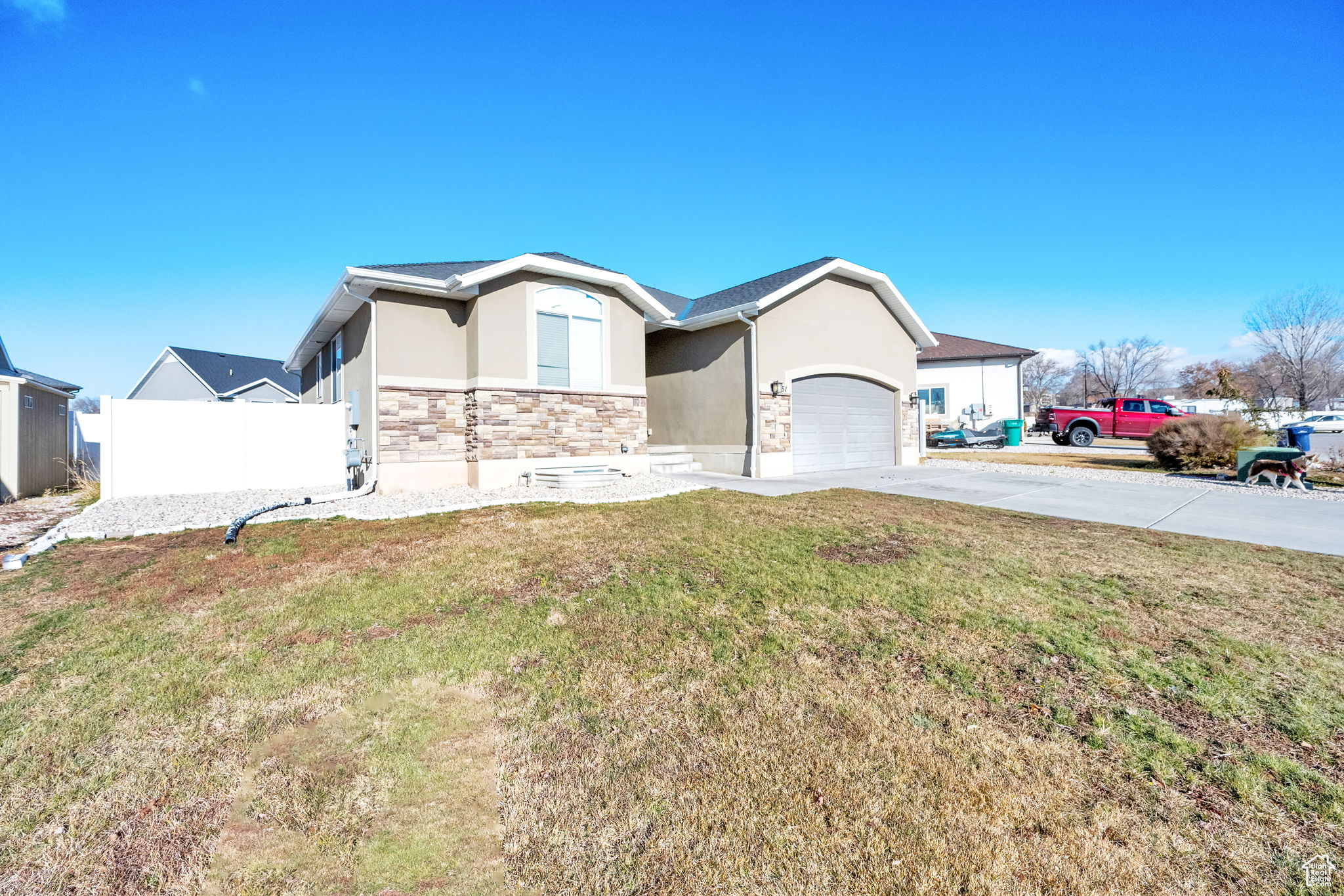 View of front of home featuring a garage and a front lawn