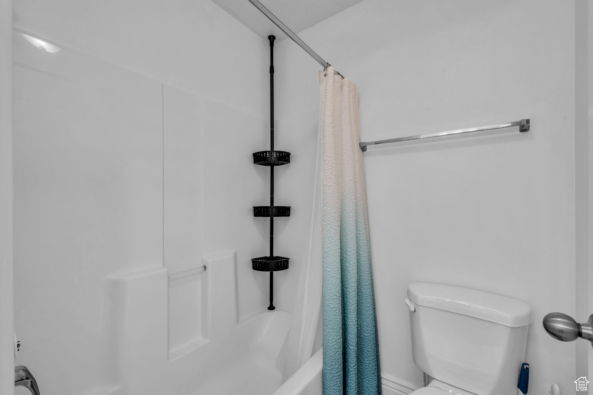 Owners Suite Bathroom with shower / bath combo with shower curtain and toilet