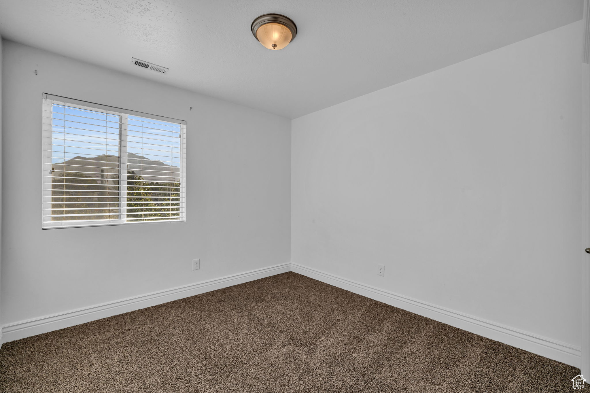 Bedroom 2 with carpet floors and a textured ceiling