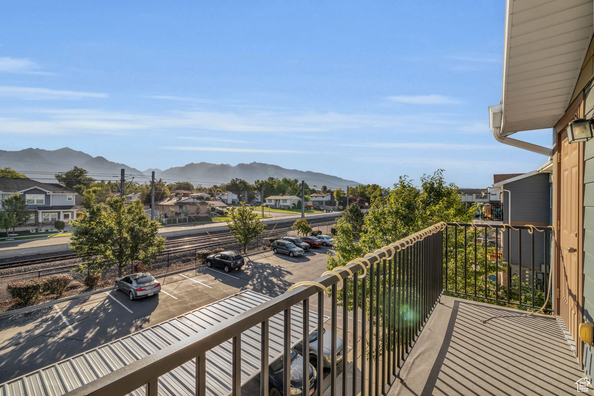 Balcony featuring a mountain view and outdoor storage closet