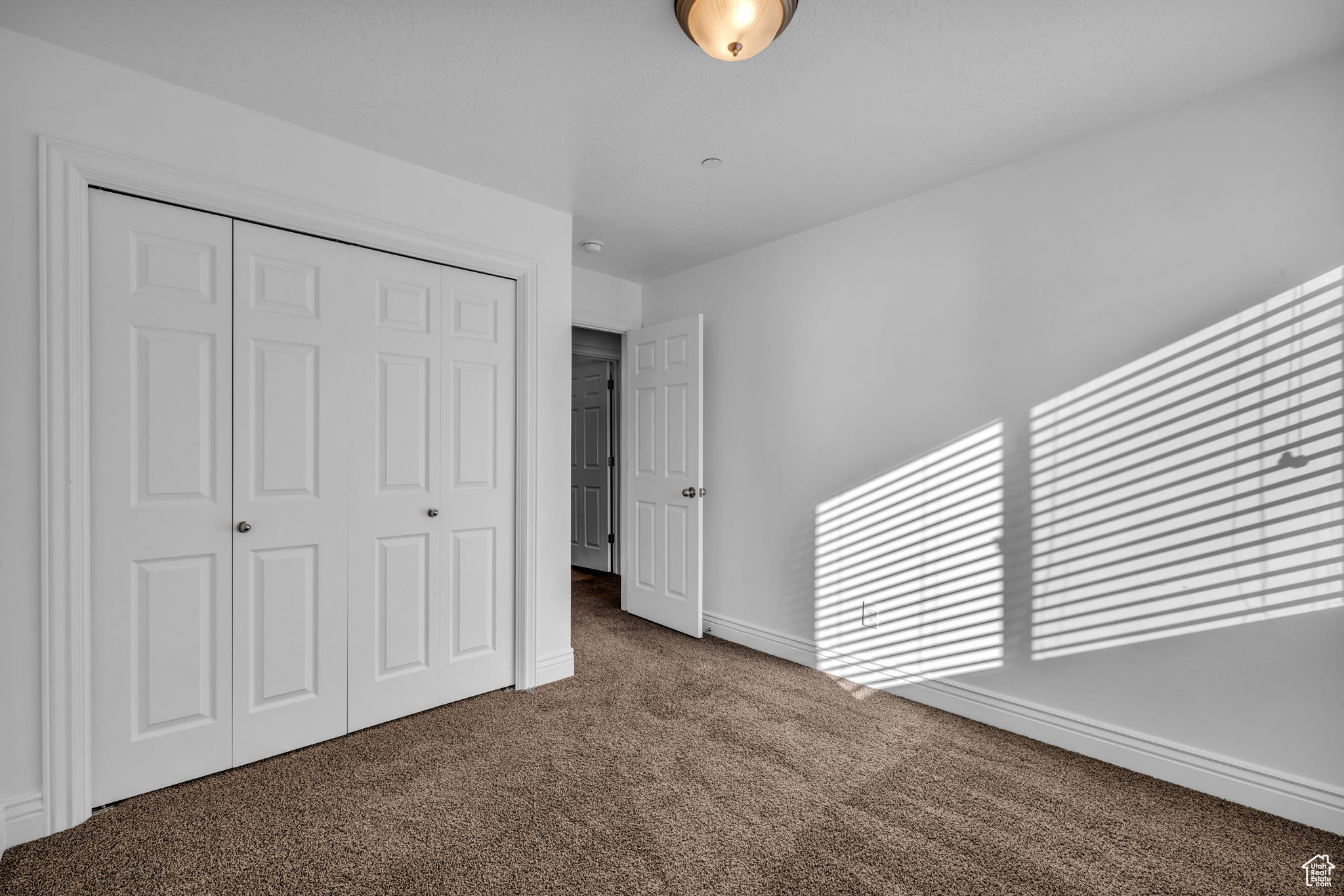 Bedroom 2 with carpet floors and a textured ceiling