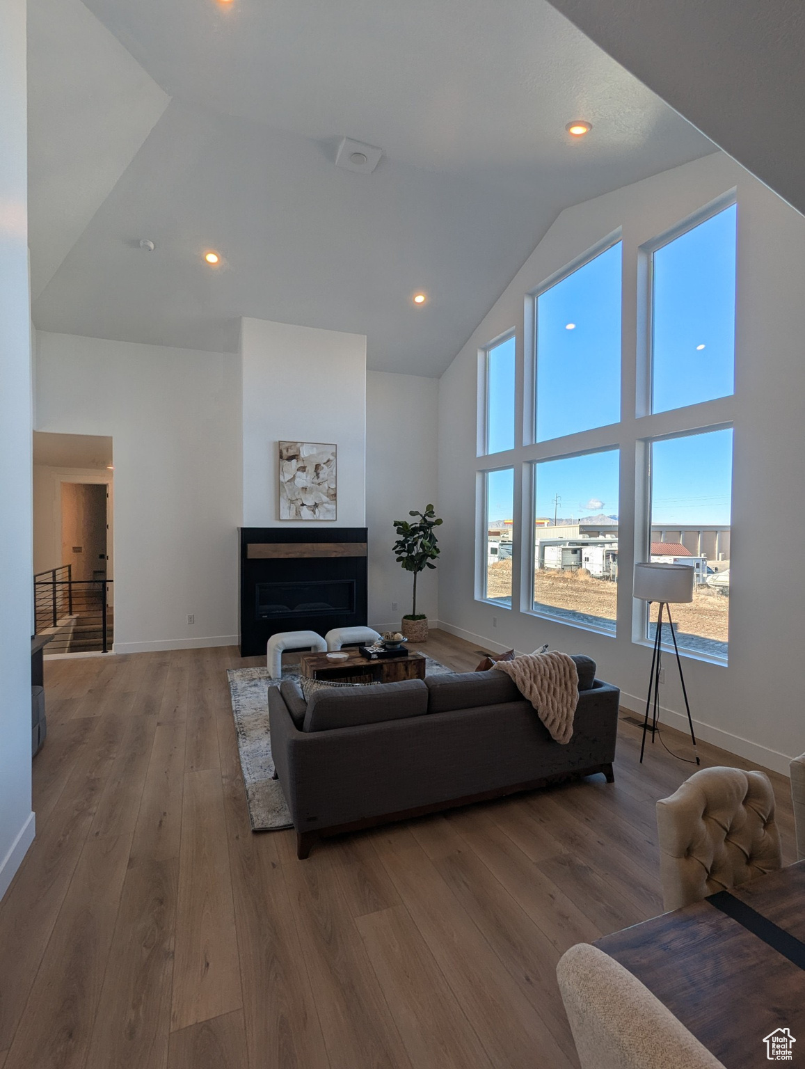 Living room with hardwood / wood-style flooring and high vaulted ceiling